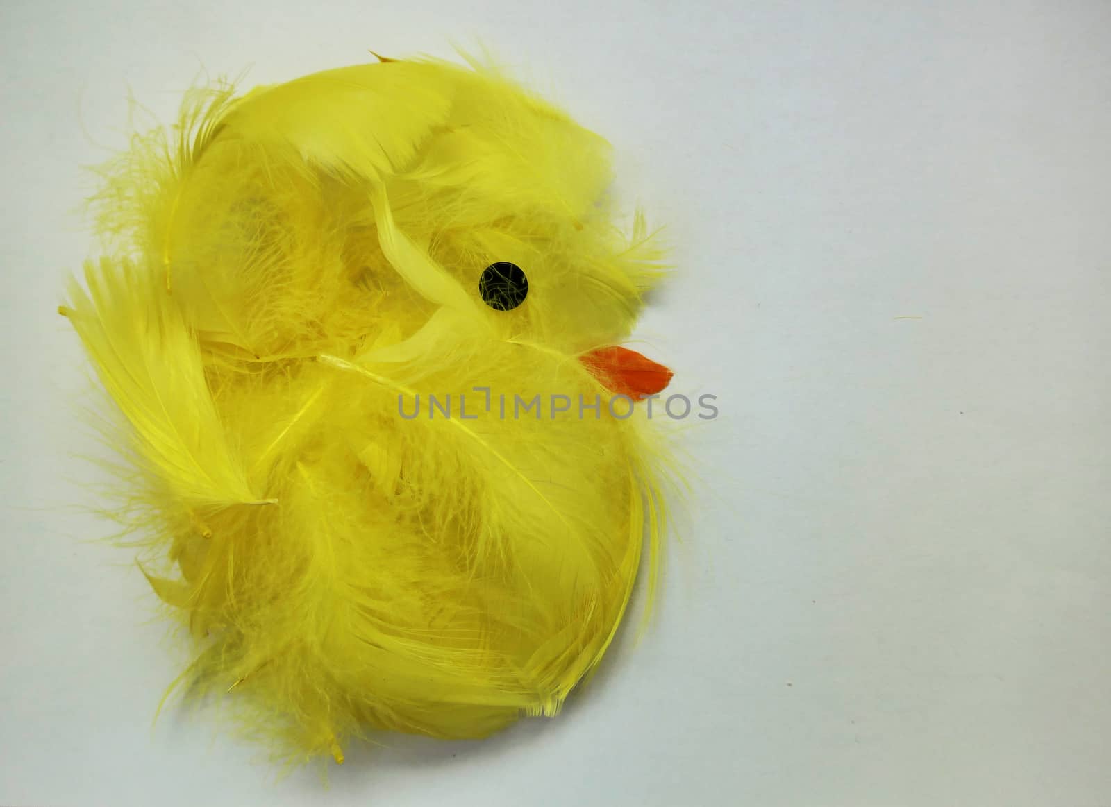 Easter chicken made of yellow and orange feather and a black pin