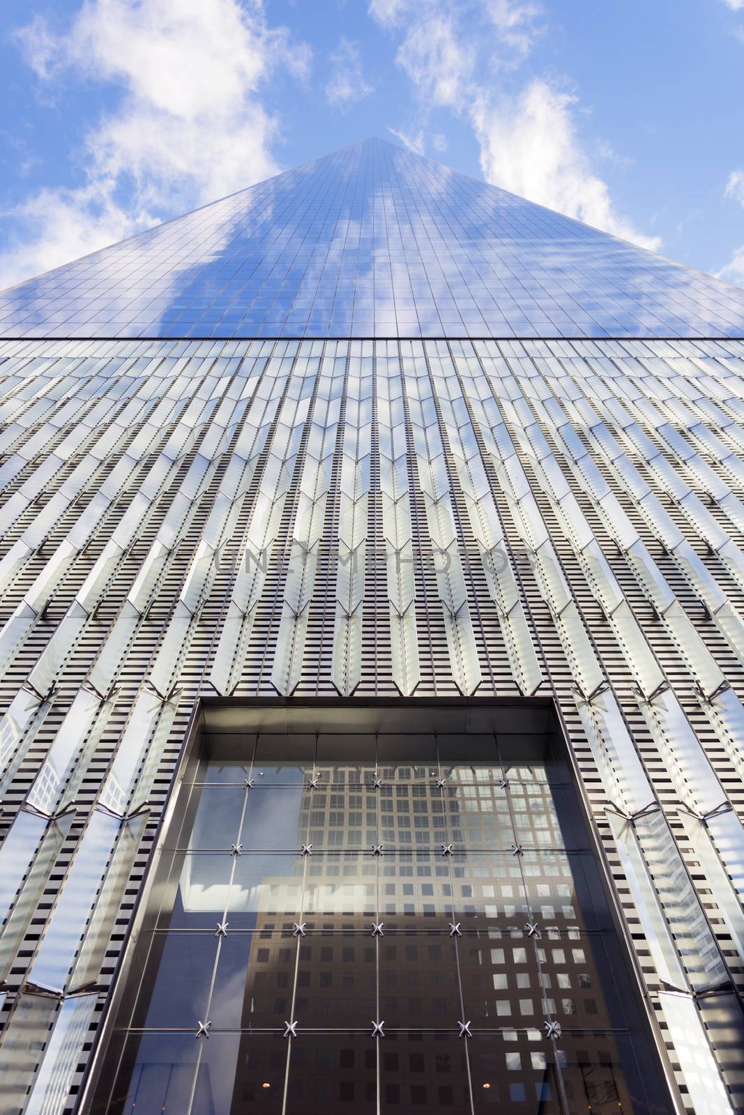 Freedom tower - Architectural buildings at lower Manhattan skyline against a blue sky in New York City - United States of America.