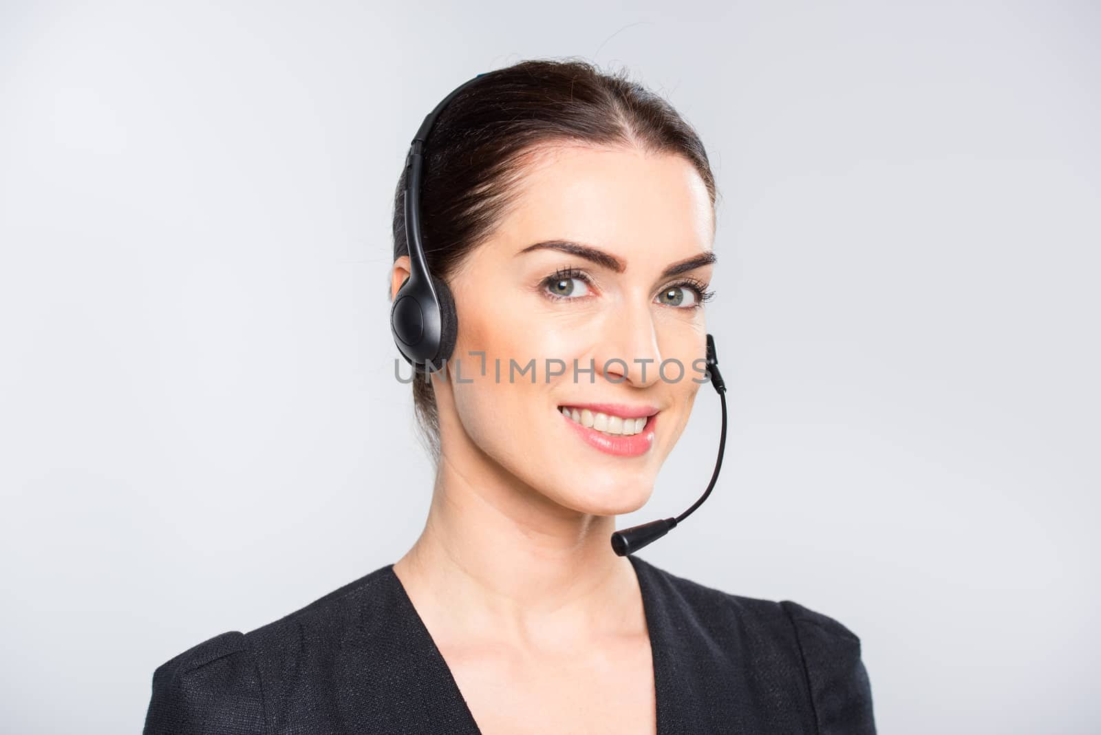 Young businesswoman in headset by LightFieldStudios