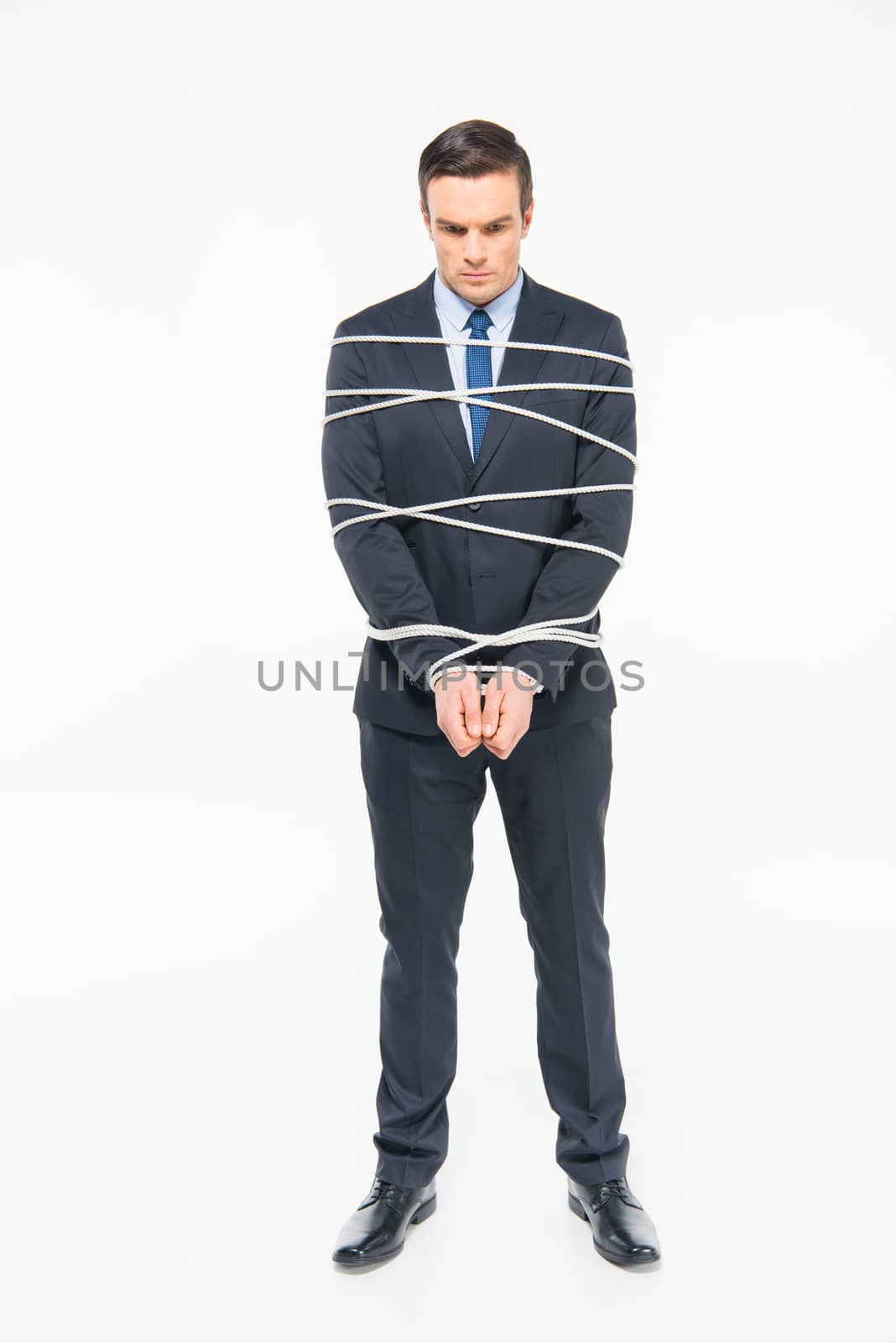 Young roped businessman by LightFieldStudios