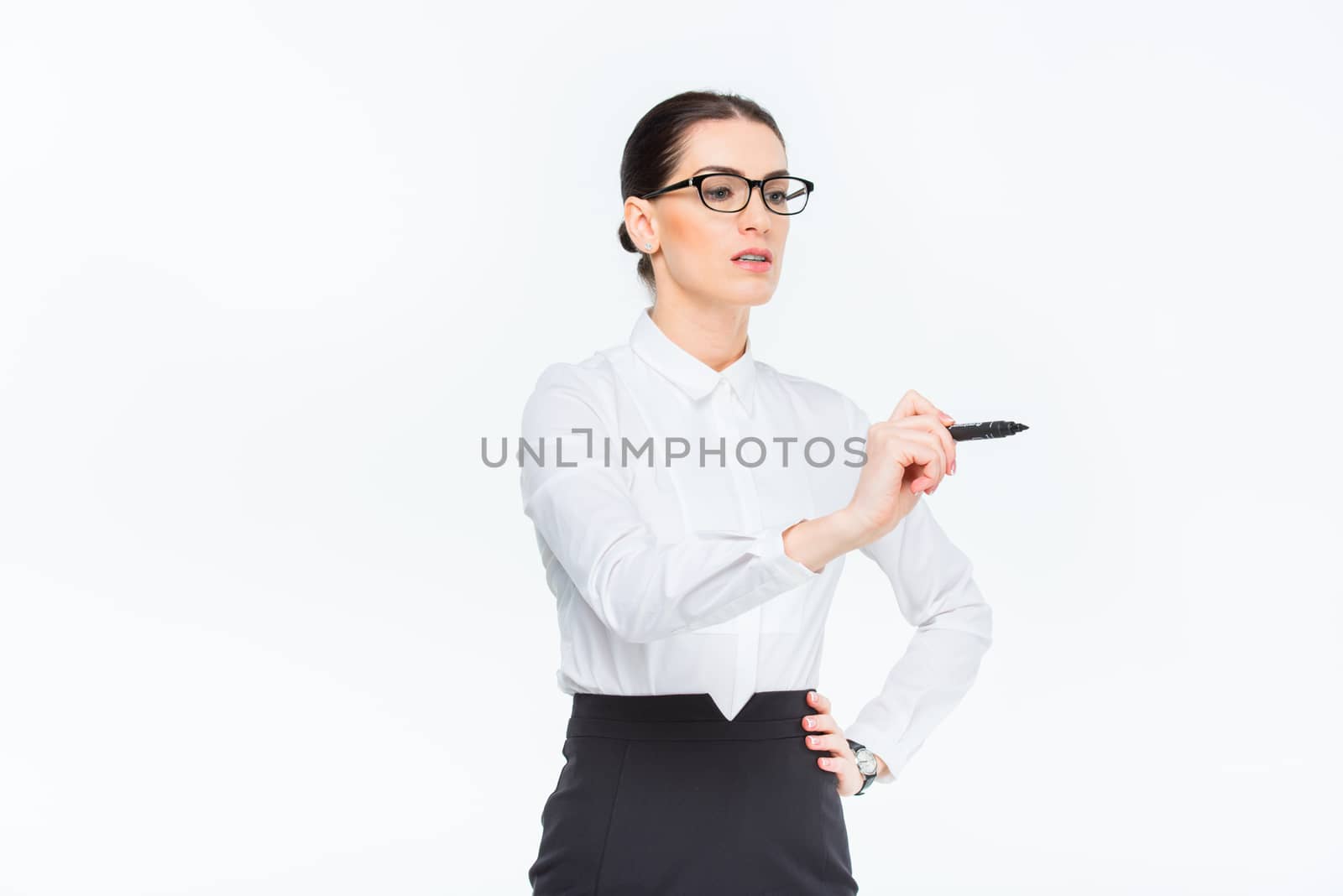 Businesswoman writing with marker by LightFieldStudios