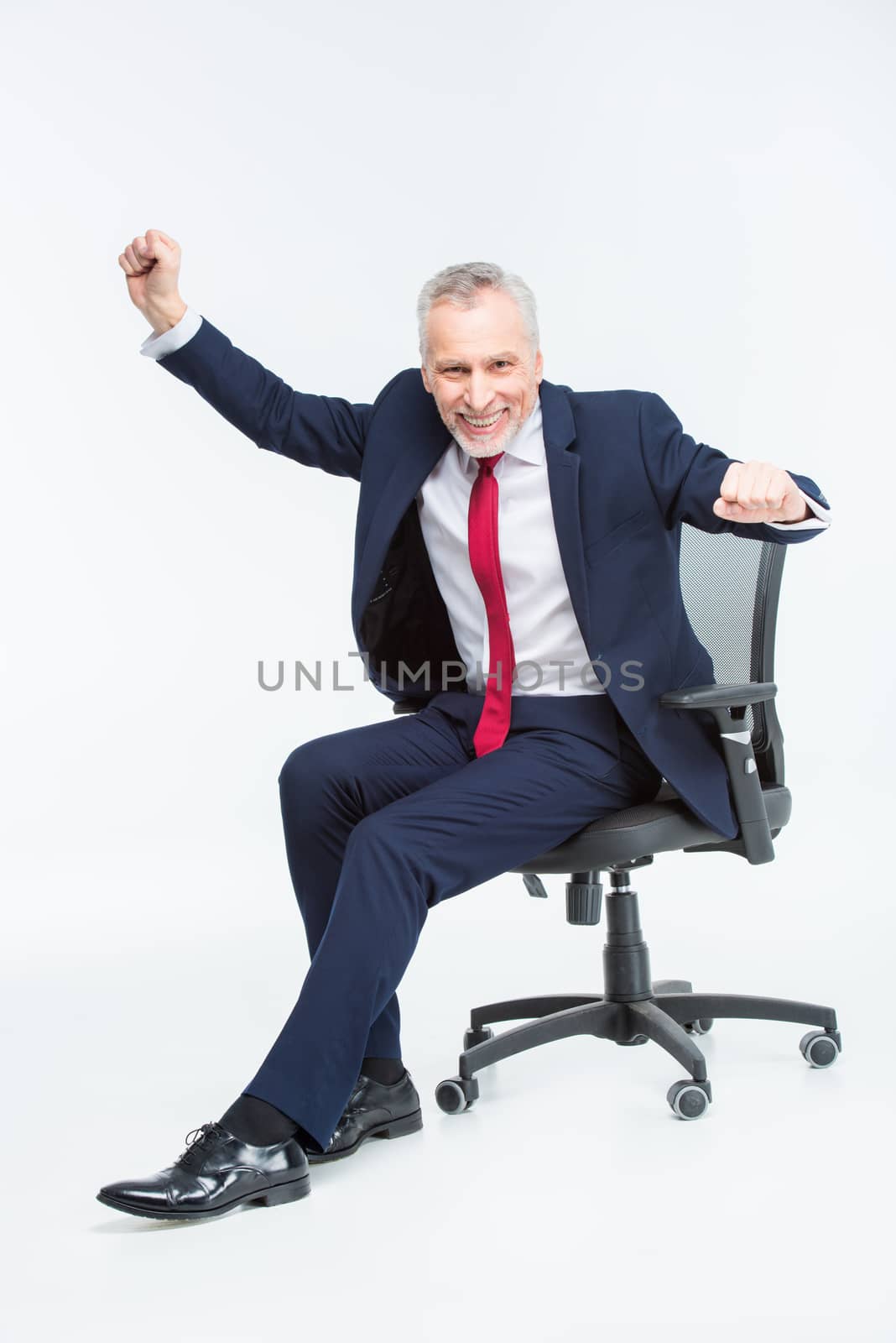 Businessman in office chair by LightFieldStudios