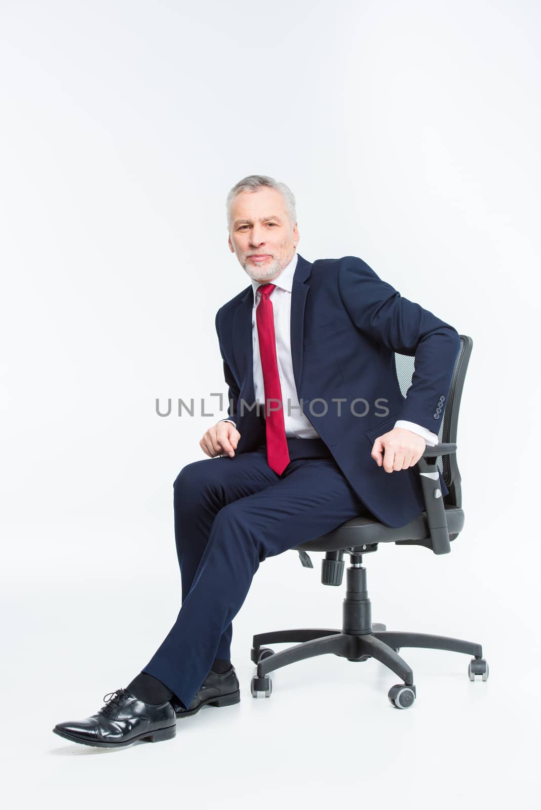 Businessman in office chair by LightFieldStudios