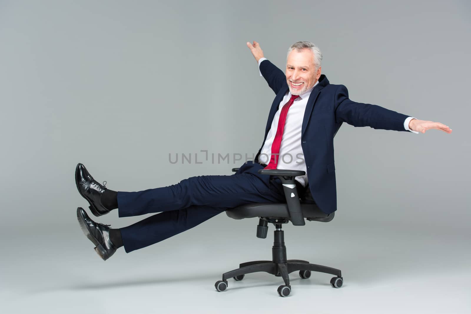 Businessman in office chair by LightFieldStudios