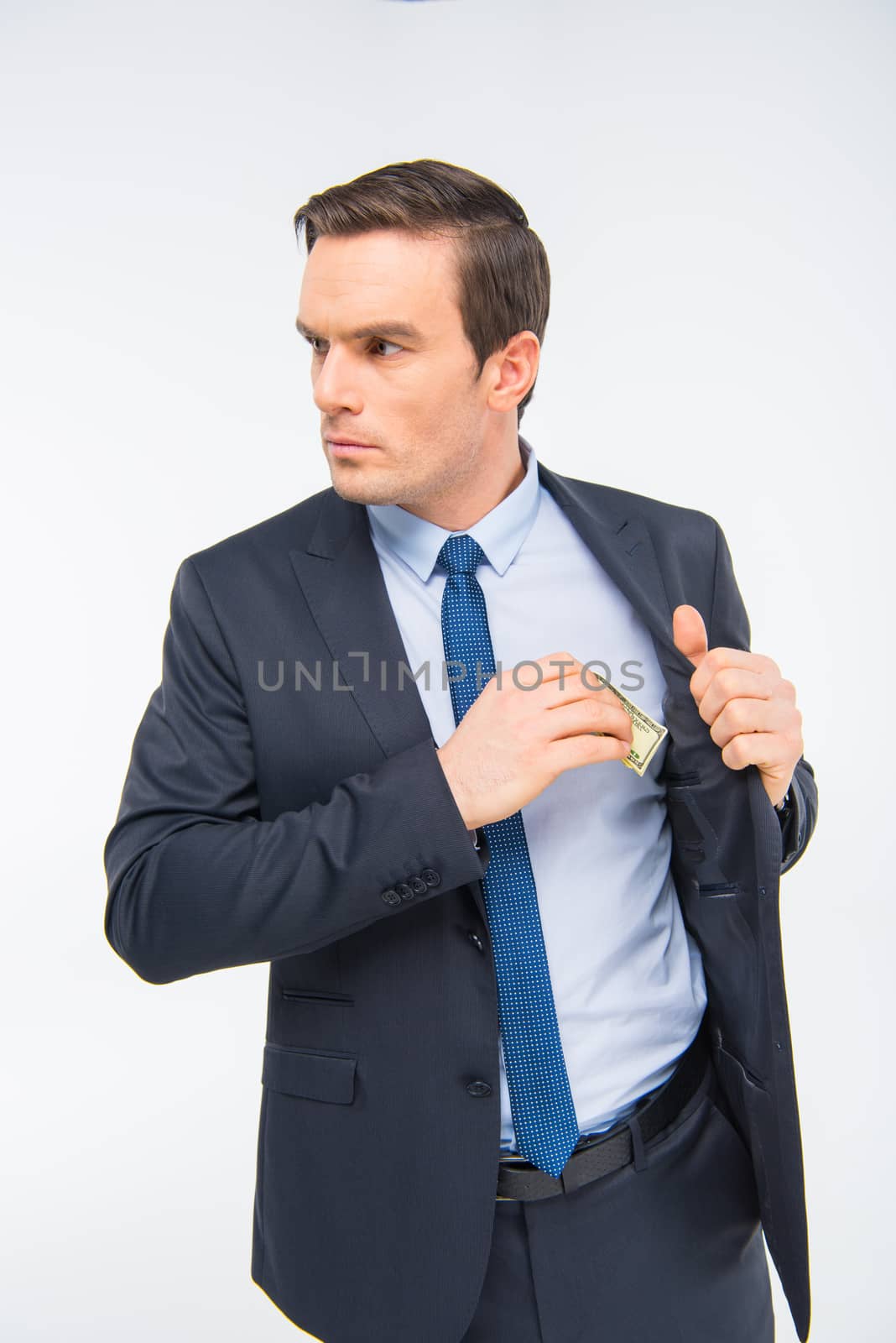 Young businessman with money  by LightFieldStudios