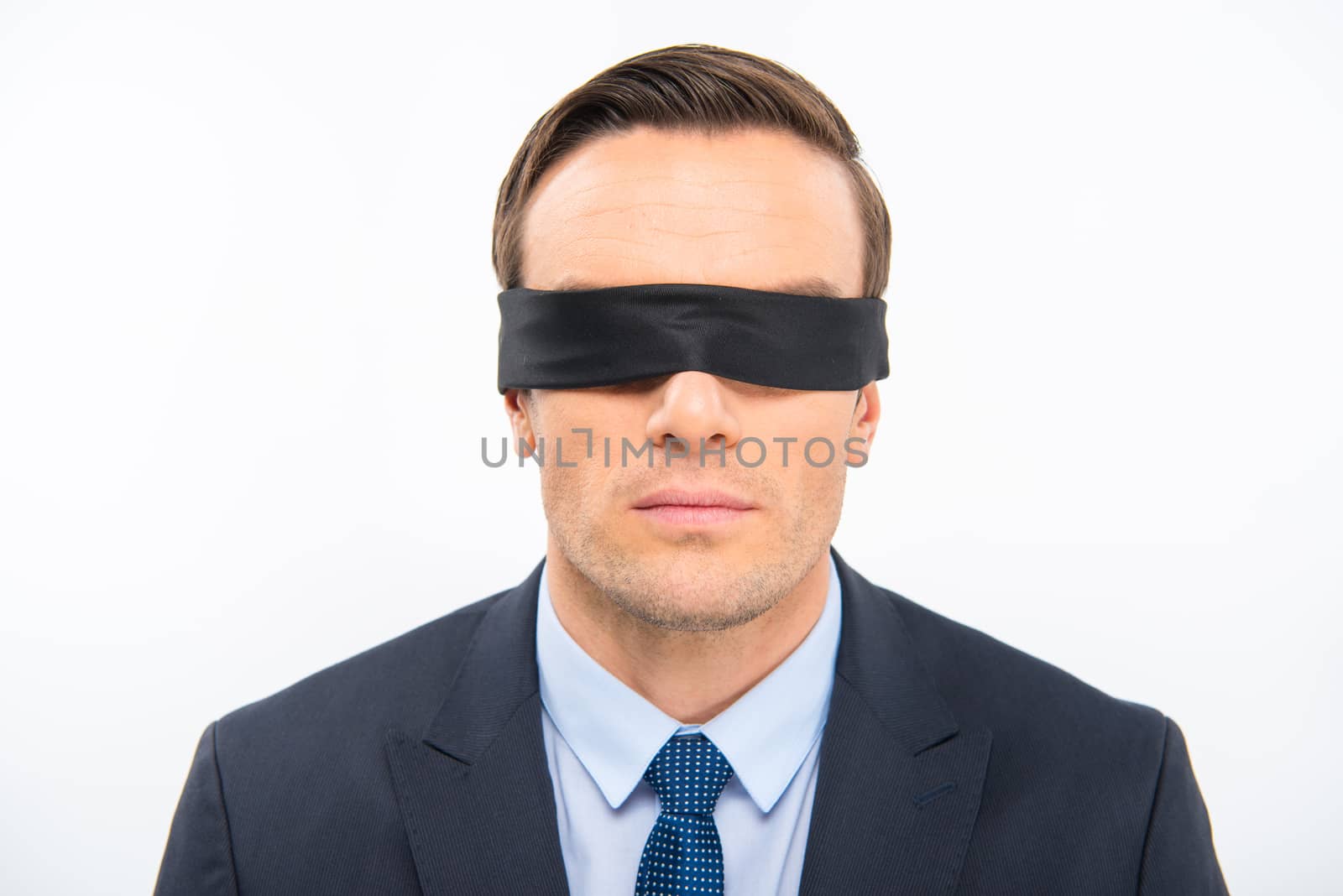 Young businessman in blindfold by LightFieldStudios