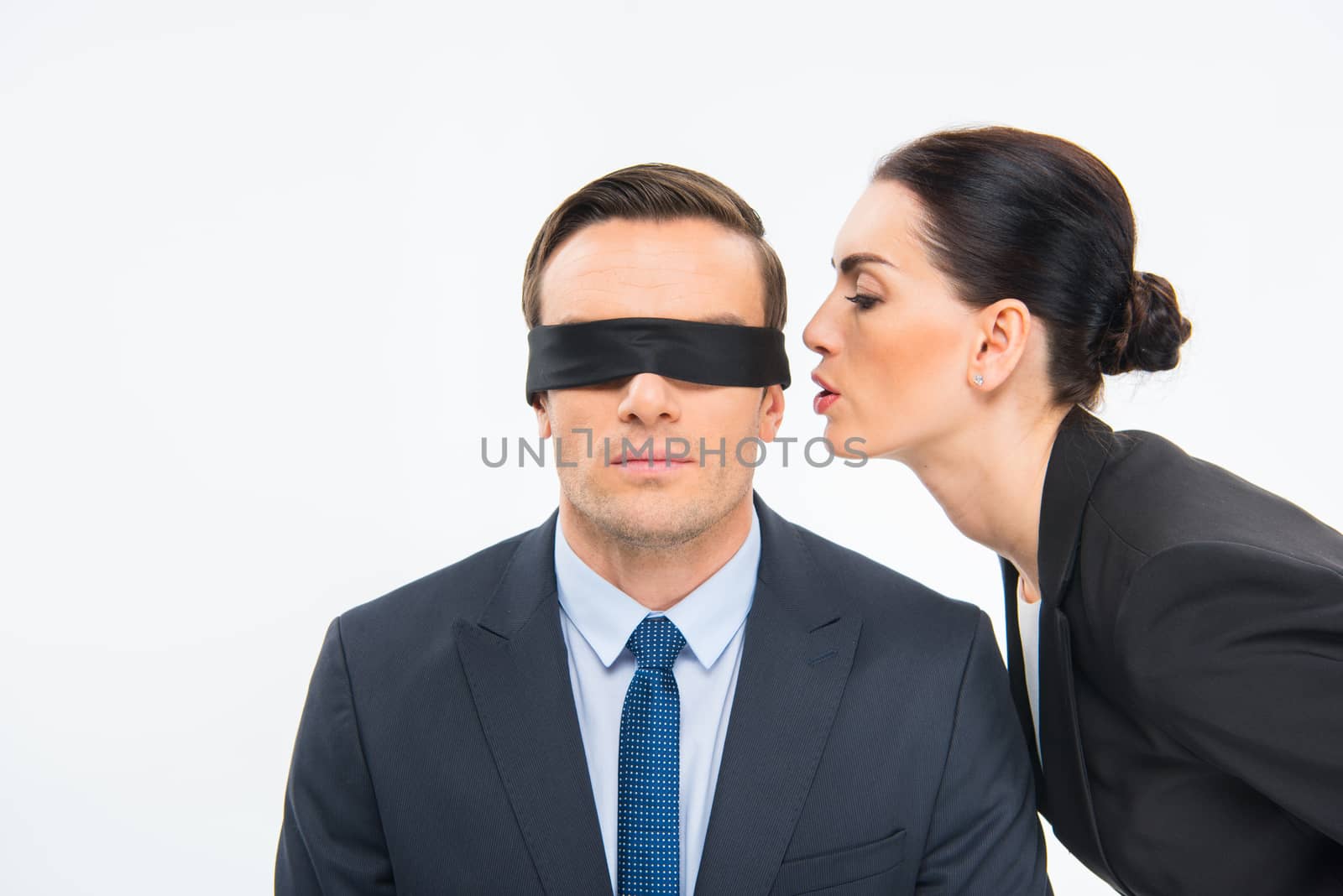 Businessman in blindfold and businesswoman by LightFieldStudios