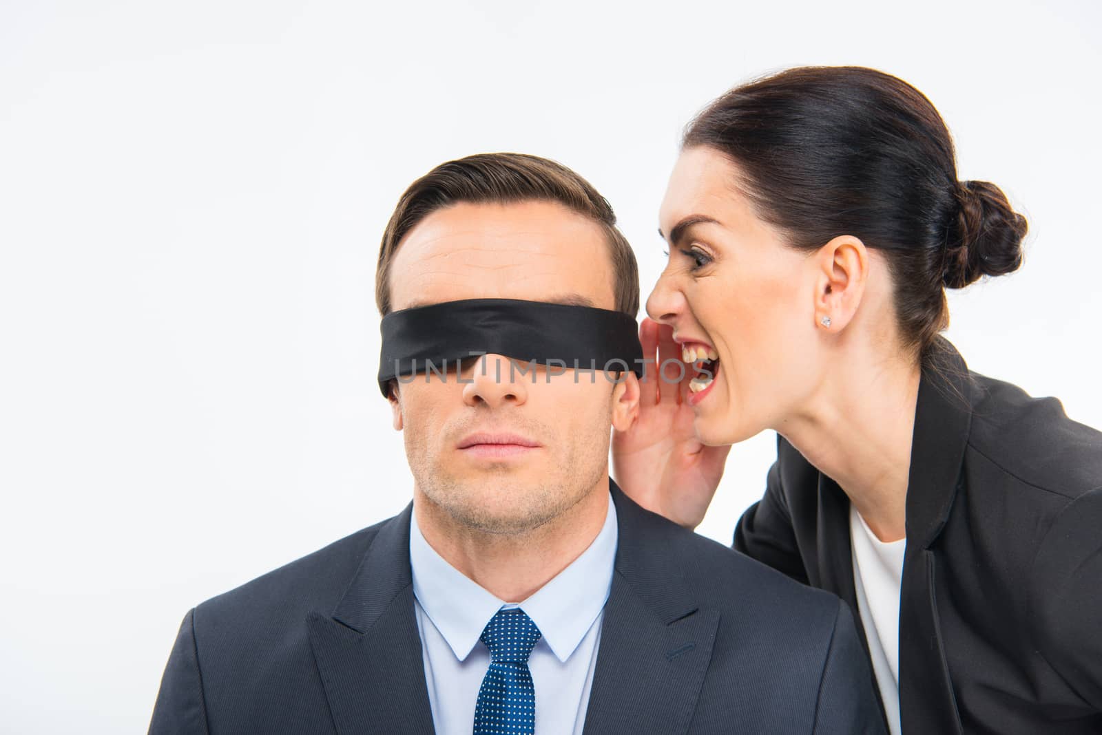 Businessman in blindfold and businesswoman by LightFieldStudios