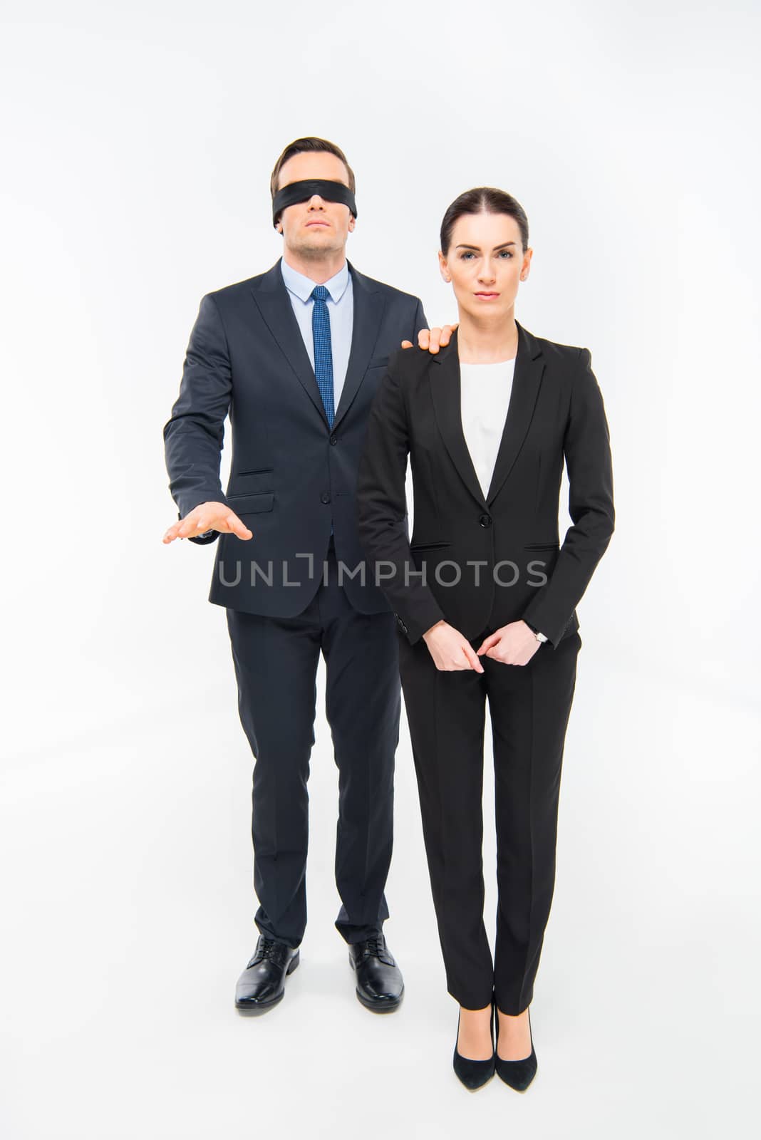 Businessman in blindfold and businesswoman by LightFieldStudios