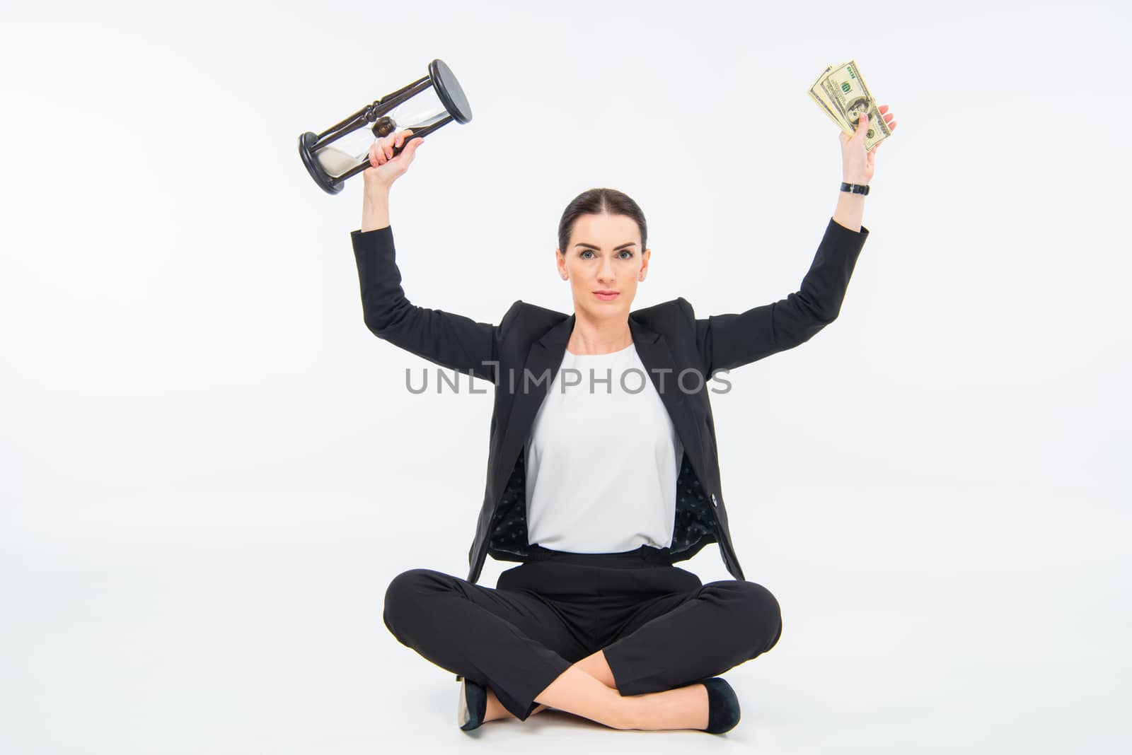 Businesswoman with hourglass and money by LightFieldStudios