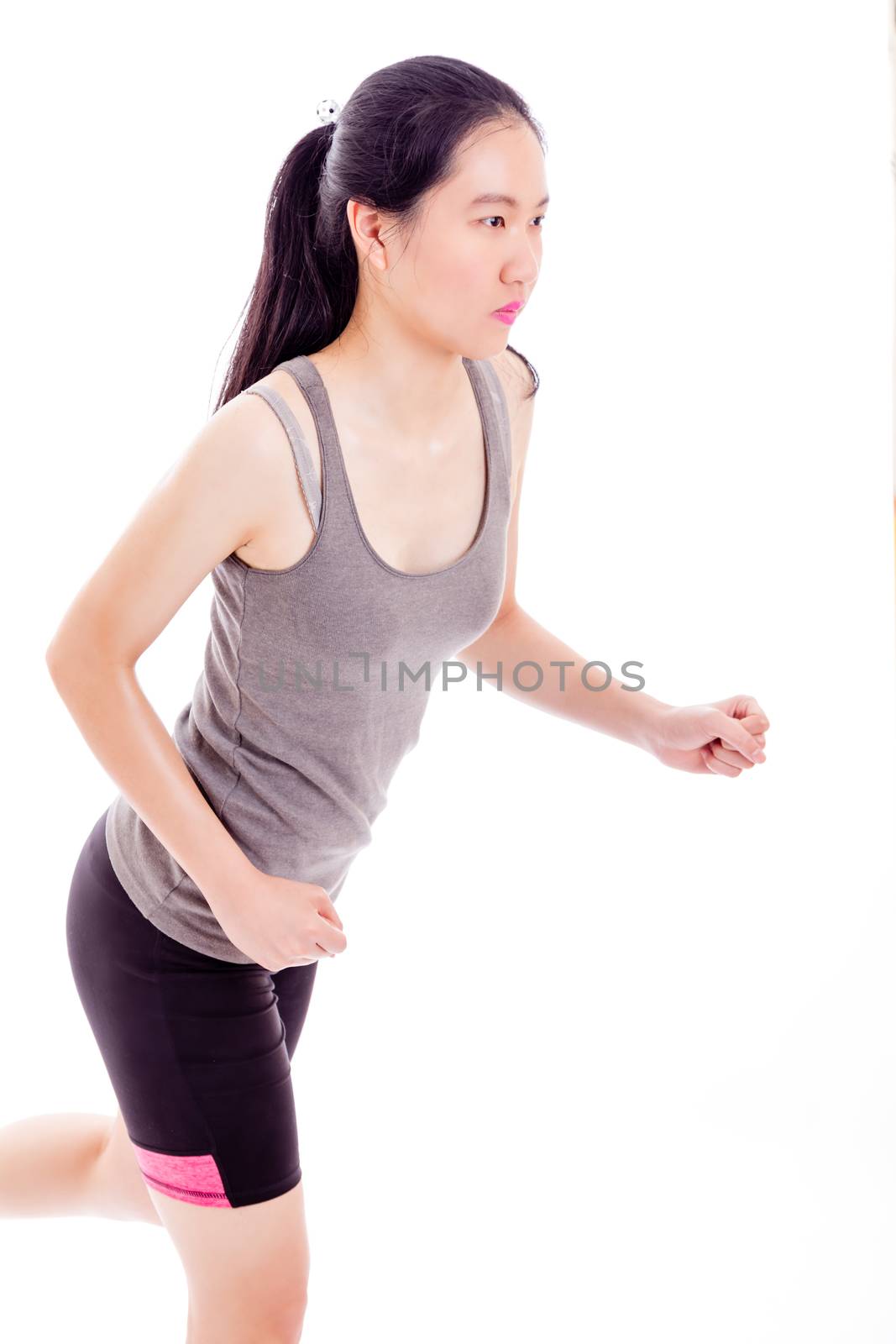 Teenage Asian girl jogging on white background
