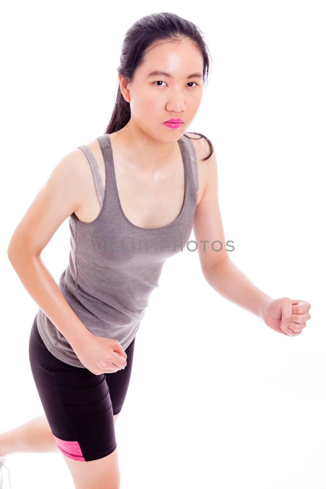 Teenage Asian girl jogging on white background