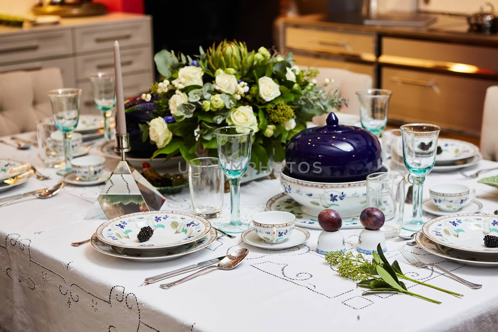 Beautifully decorated table set with flowers, candles, plates and serviettes for wedding or another event in the restaurant. by sarymsakov