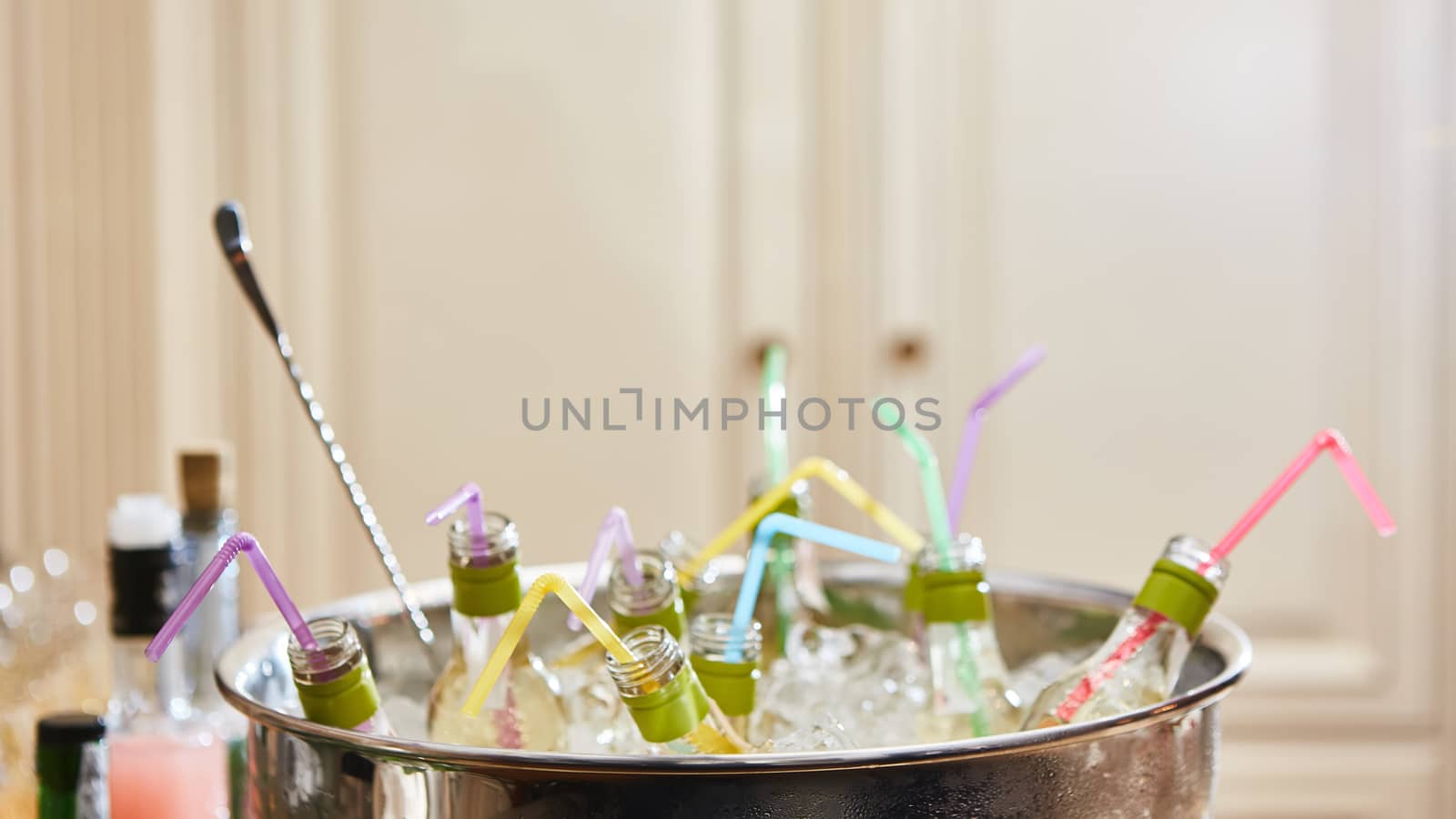 bottles with tasty drink in ice. Shallow dof.