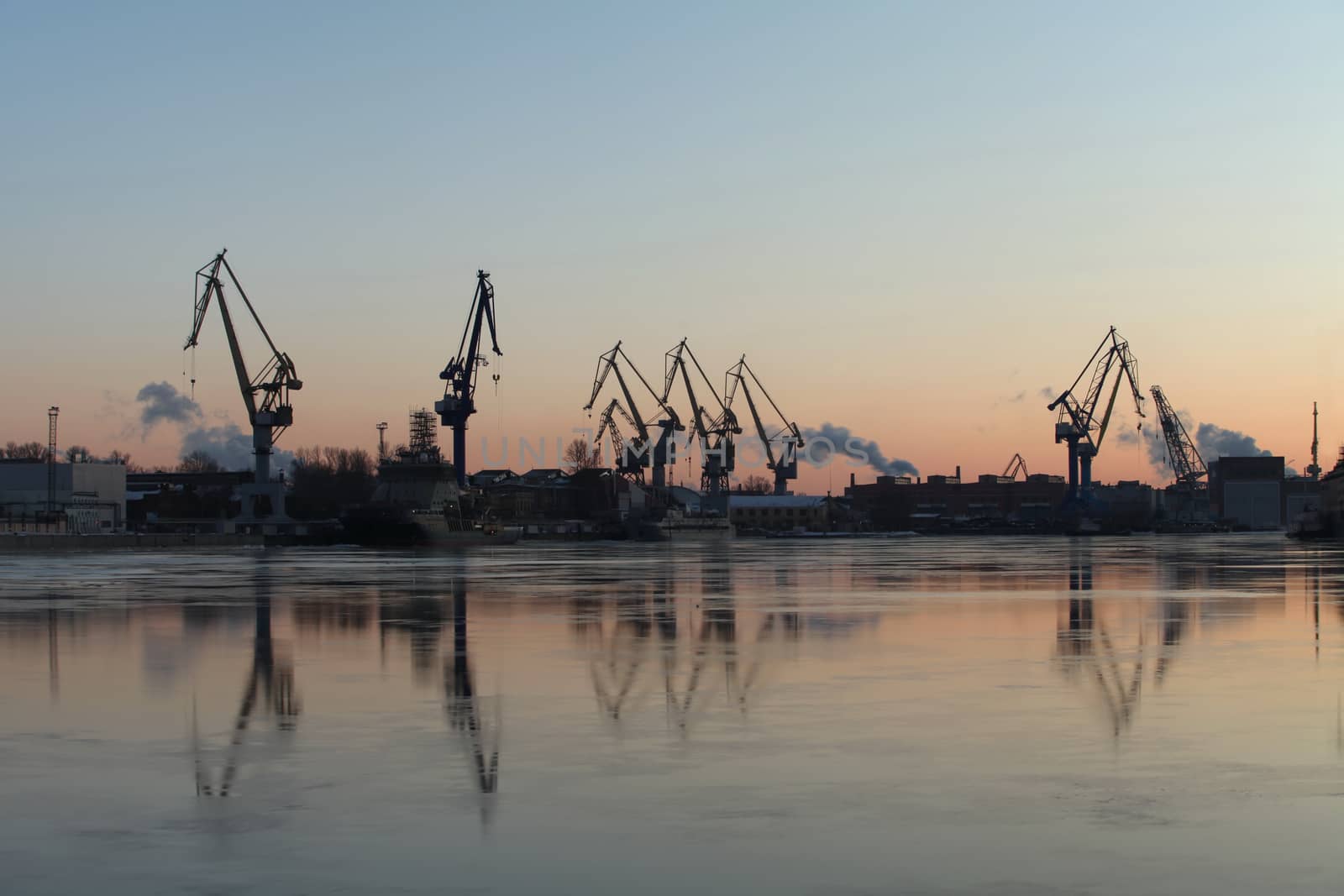 Silhouettes portal cranes reflection on water port St. Petersburg