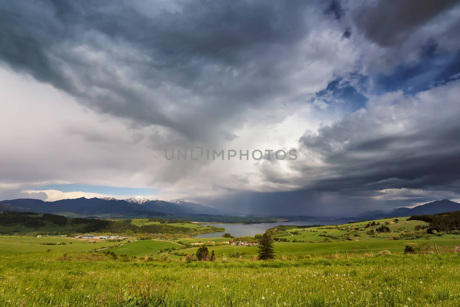 Spring rain and storm in mountains. Green spring hills of Slovakia. Spring stormy scene