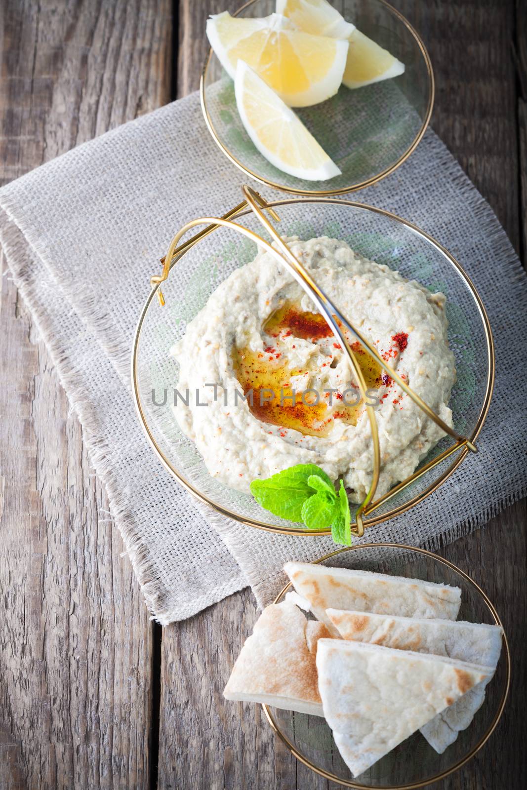 Baba ghanoush, eggplant dip mediterranean food on a wooden surface