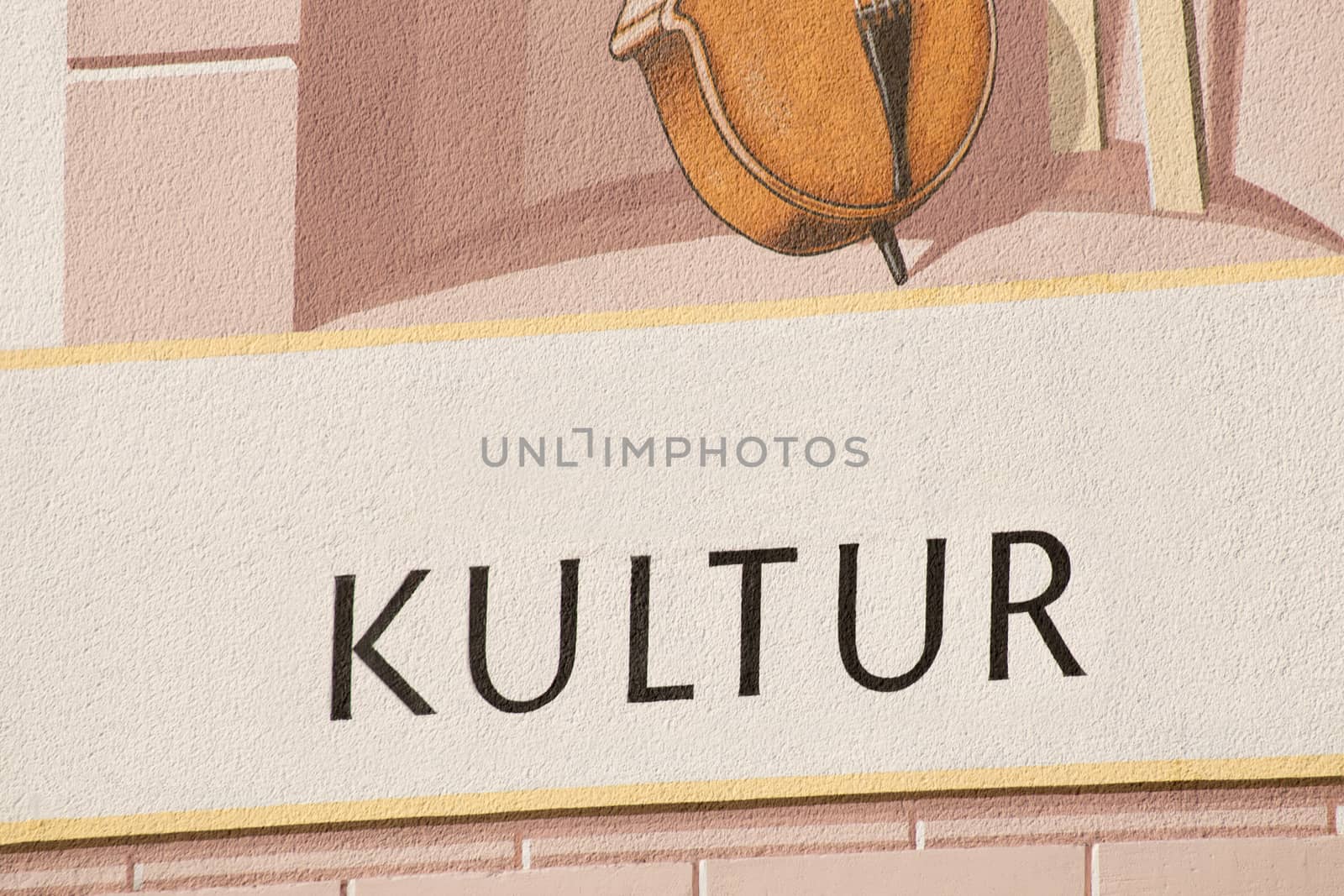The german word for culture and part of a musical instrument on a house wall