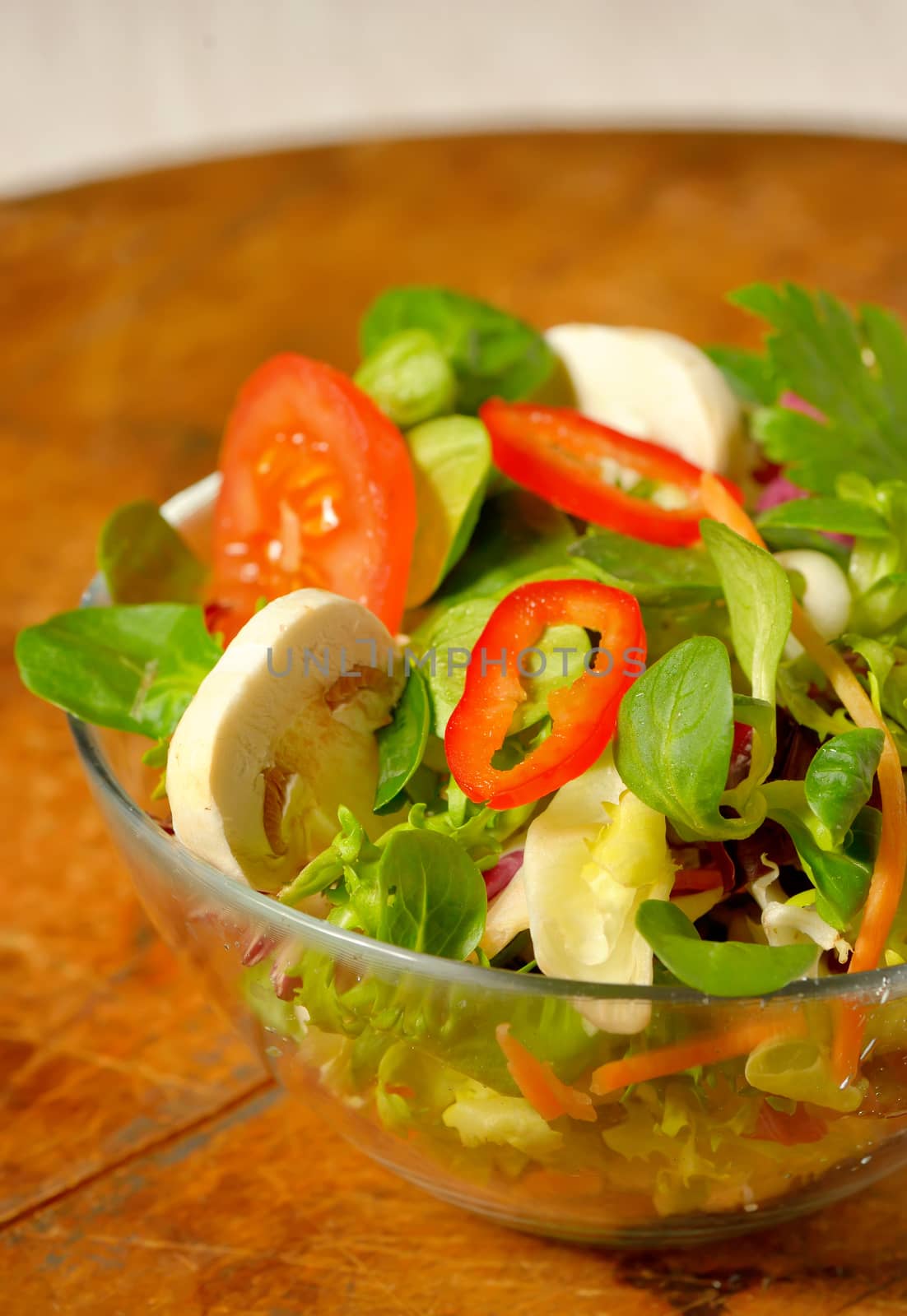 Tasty fresh salad on wooden table