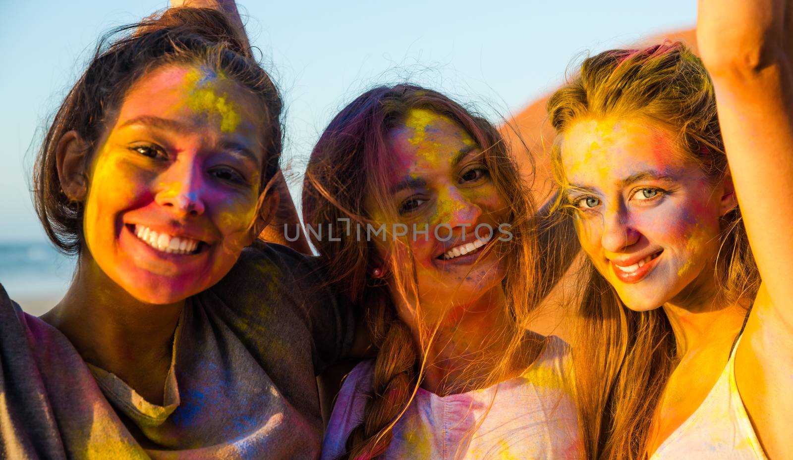 Best friends full of colored powder all over the body