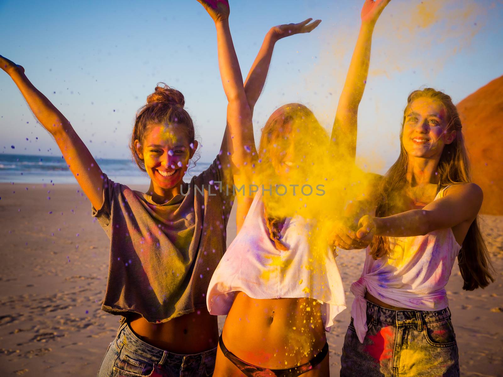 Best friends full of colored powder all over the body