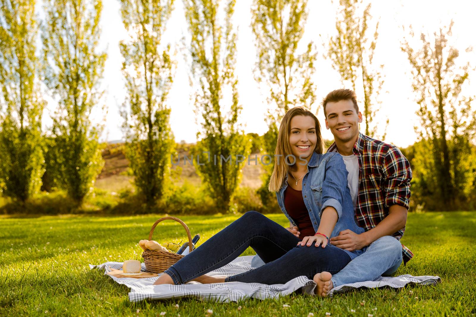 Shot of a beautiful couple on the park making a picnic and having fun