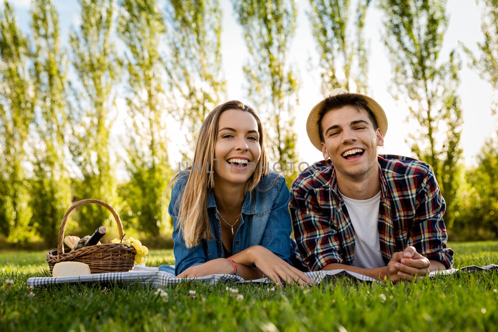 Shot of a beautiful couple on the park having fun together while making a picnic