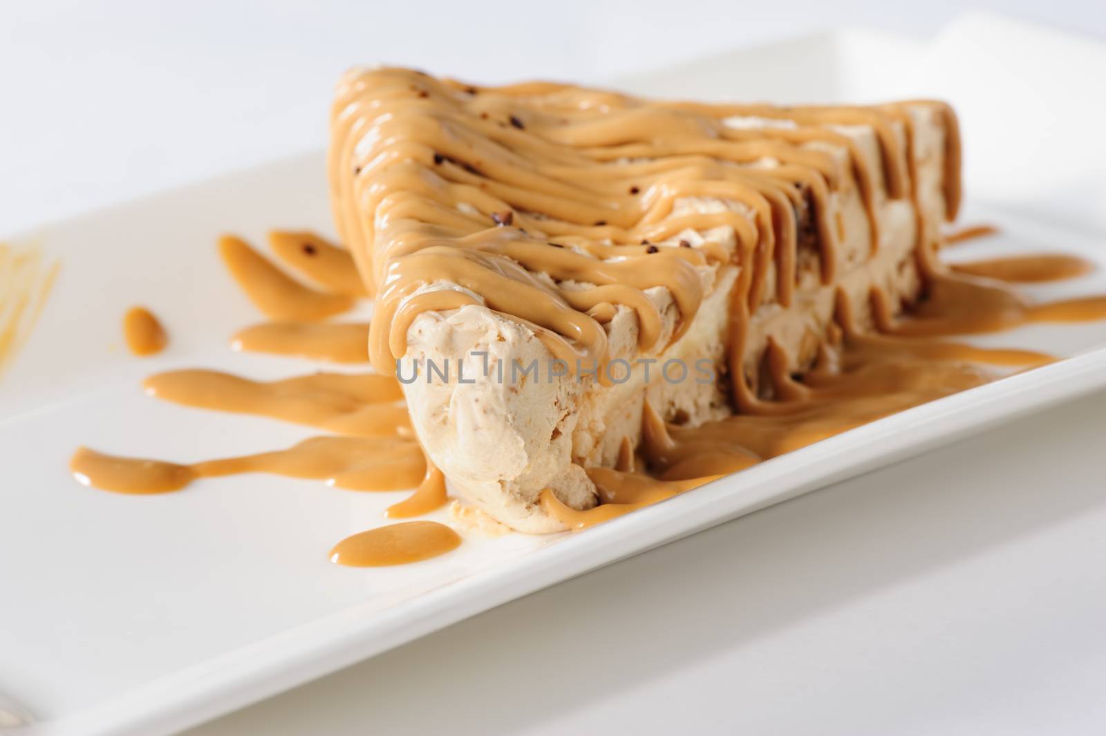 Delicious frozen cheesecake with caramel and sweet condensed milk topping