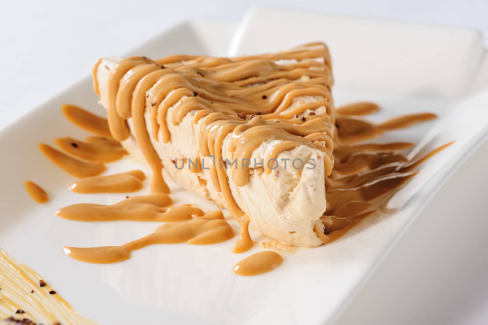 Delicious frozen cheesecake with caramel and sweet condensed milk topping