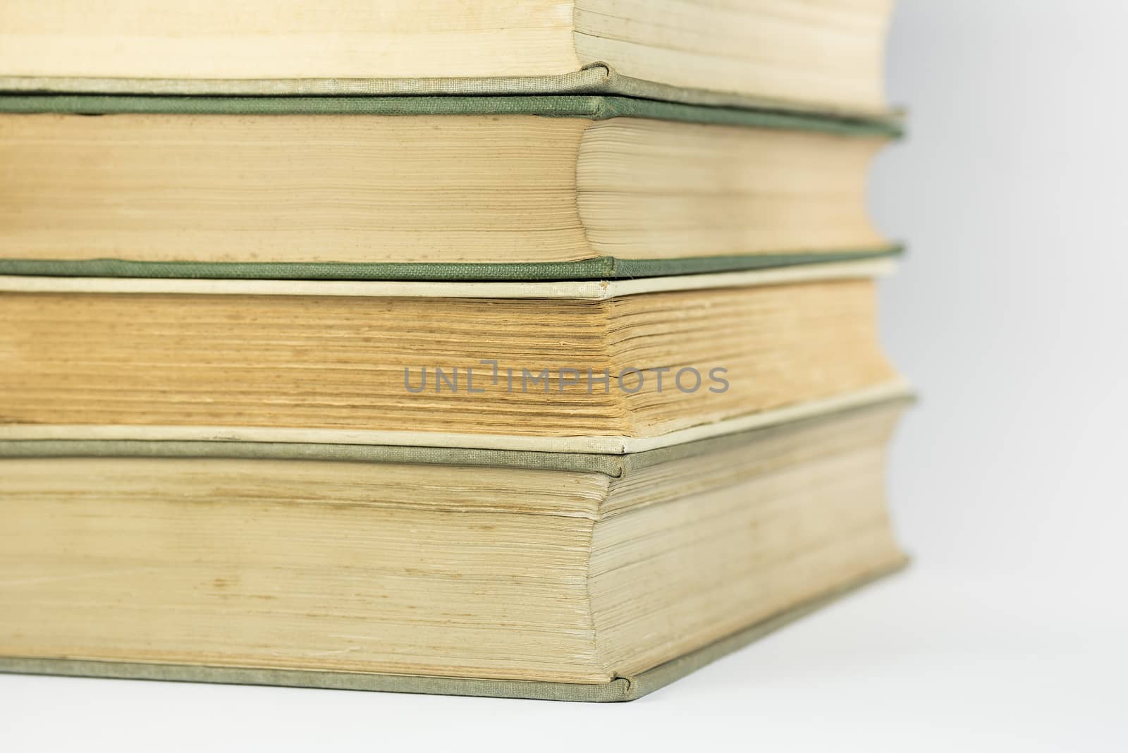 Stacked old bound and yellowed books as background picture
