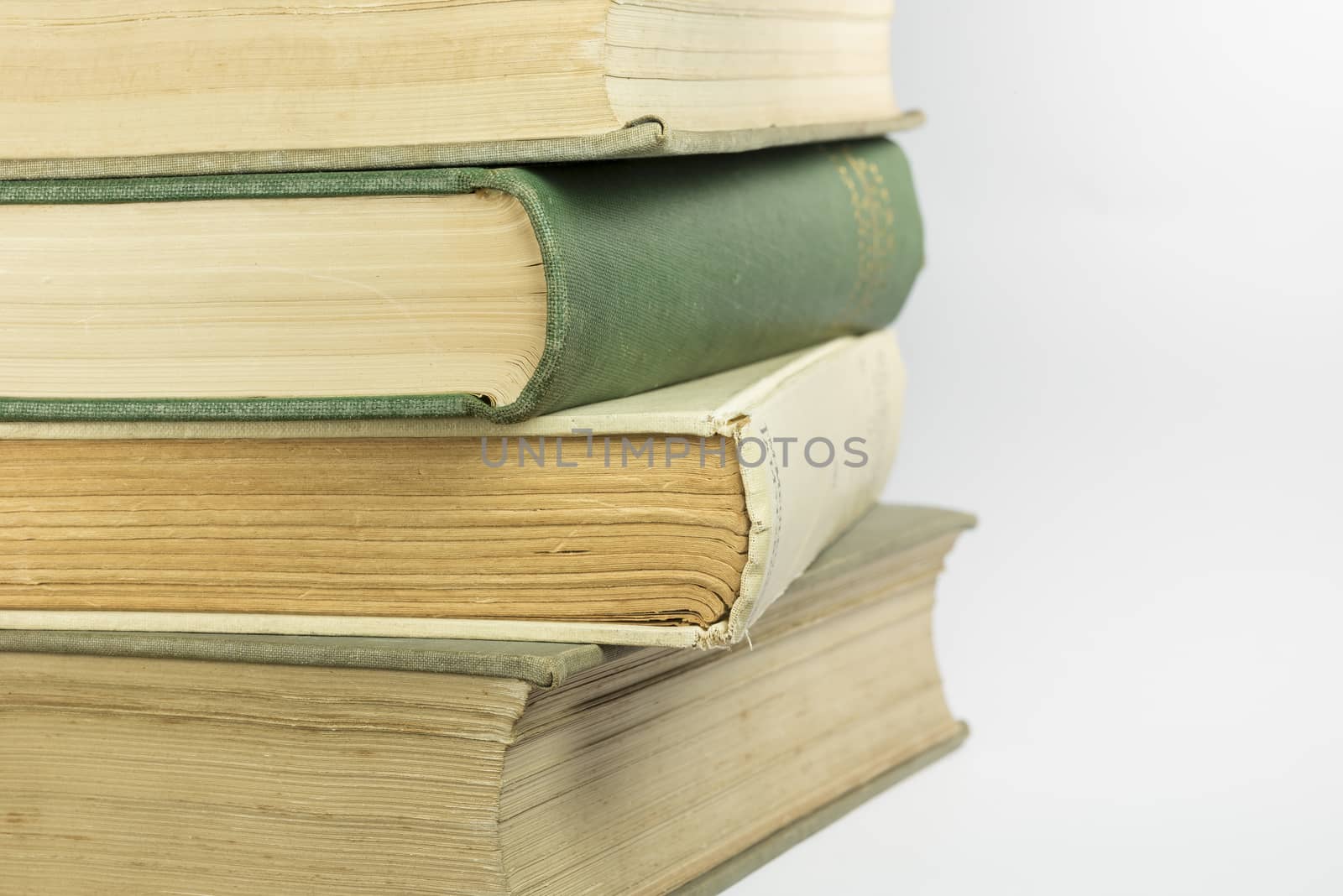Stacked old bound and yellowed books as background picture
