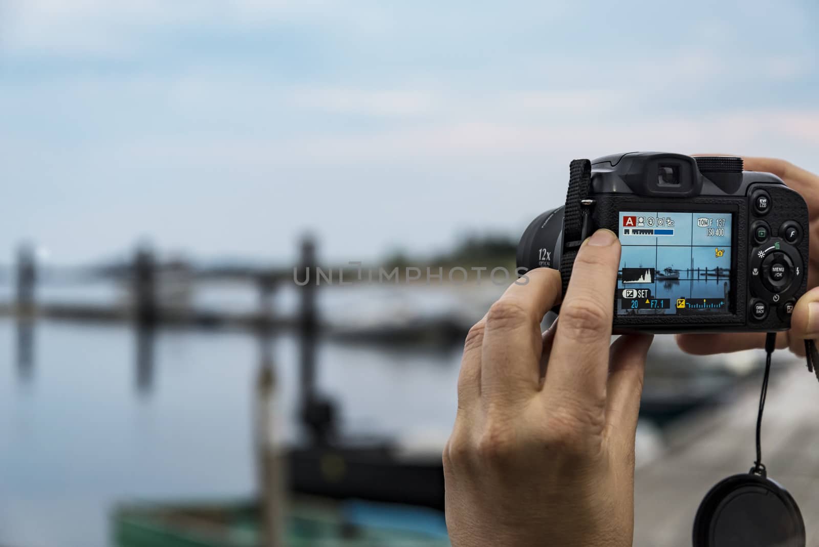 Female hands taking a photo of landscape