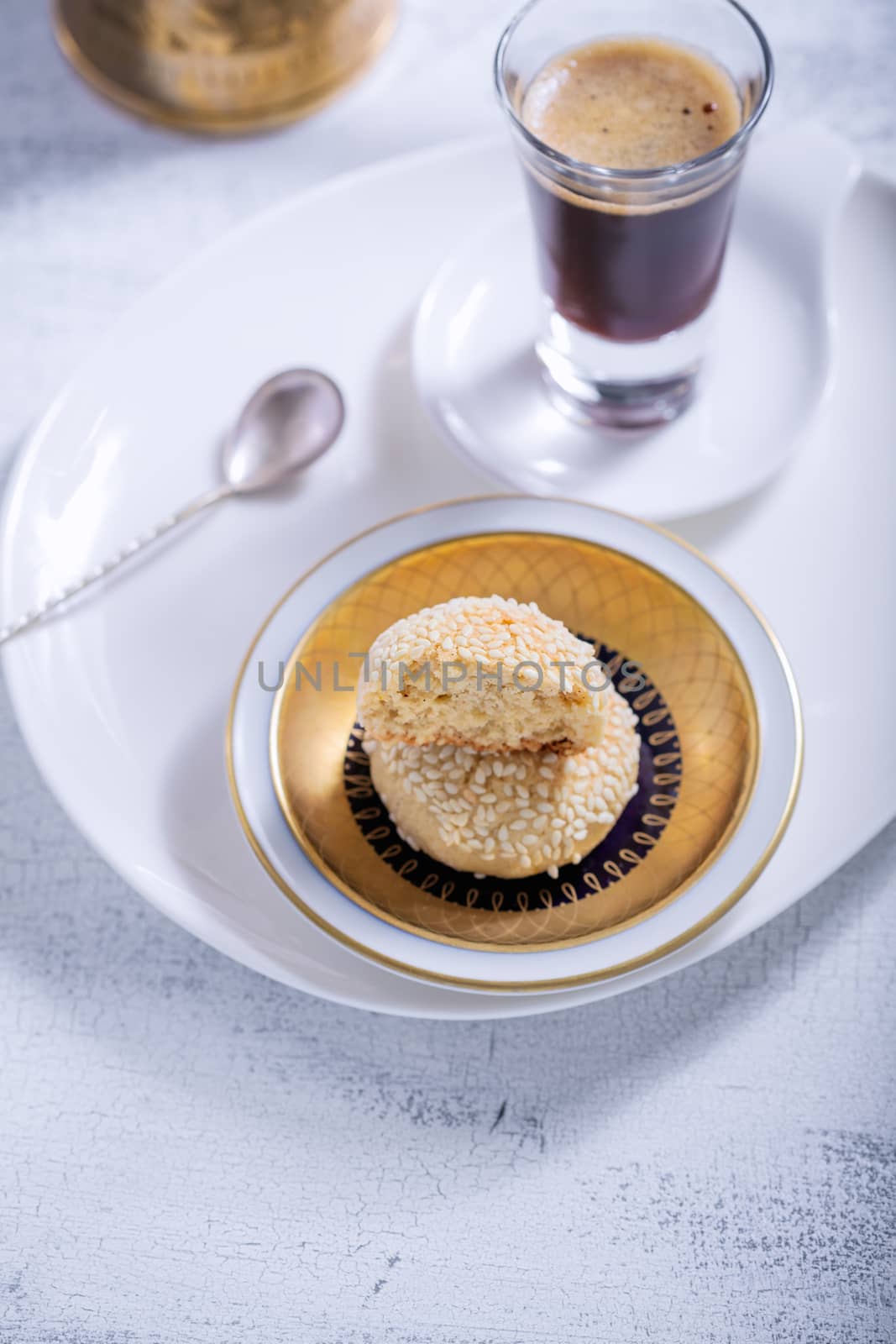 Almonds cookies and coffee served on a table