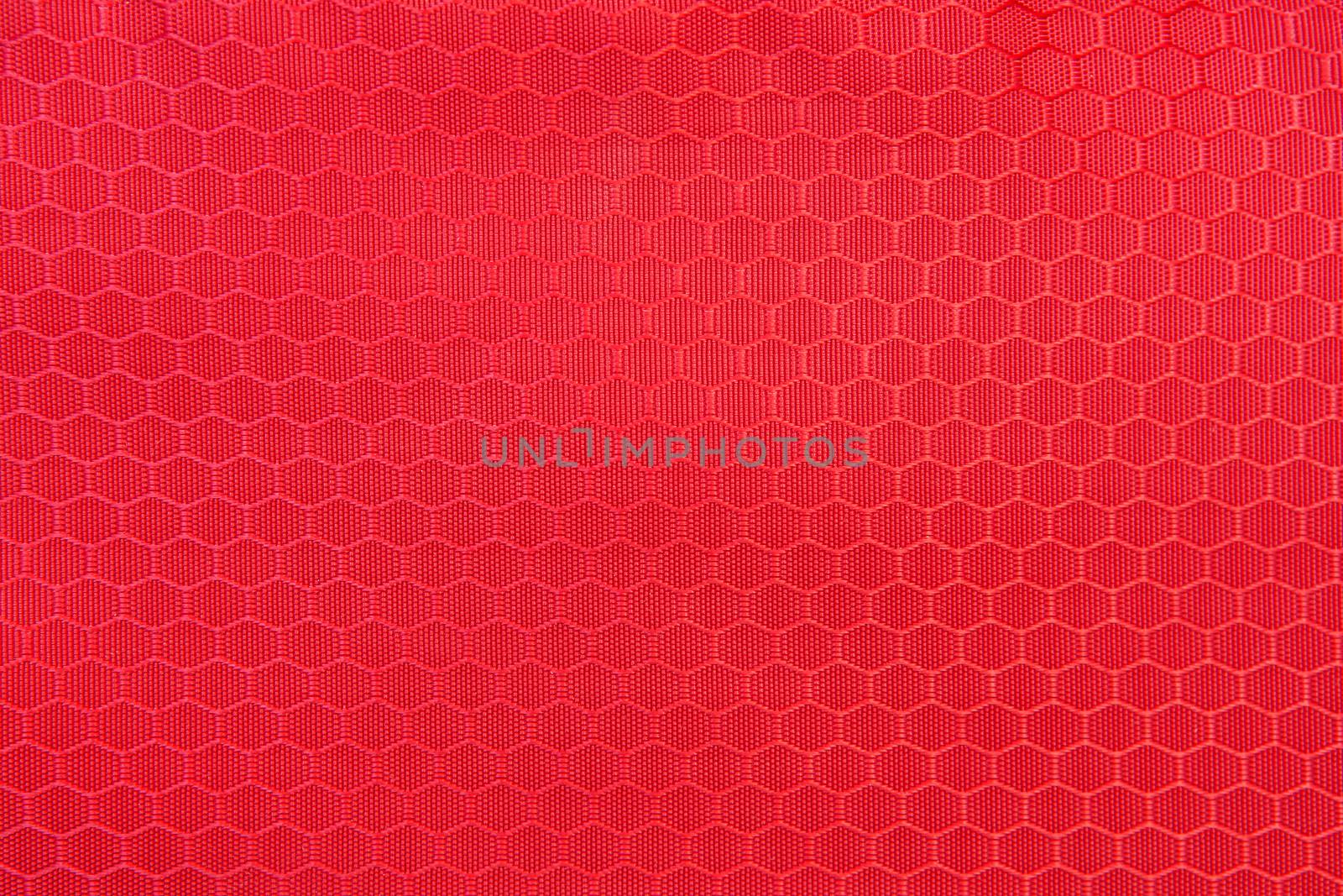 red honeycomb background texture. Texture background of polyester fabric. Plastic weave fabric pattern