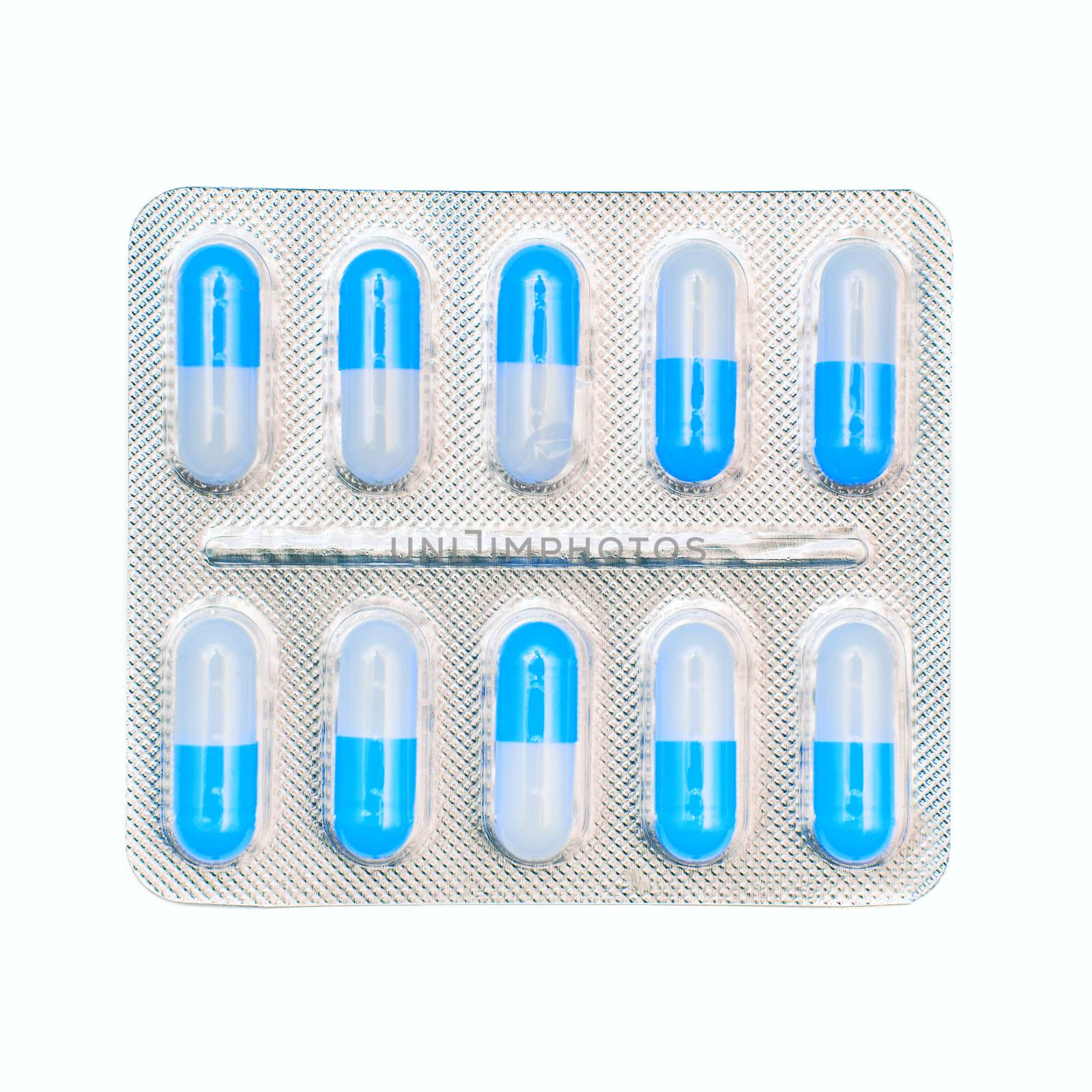 Blister pack of blue and white capsules isolated on white background.