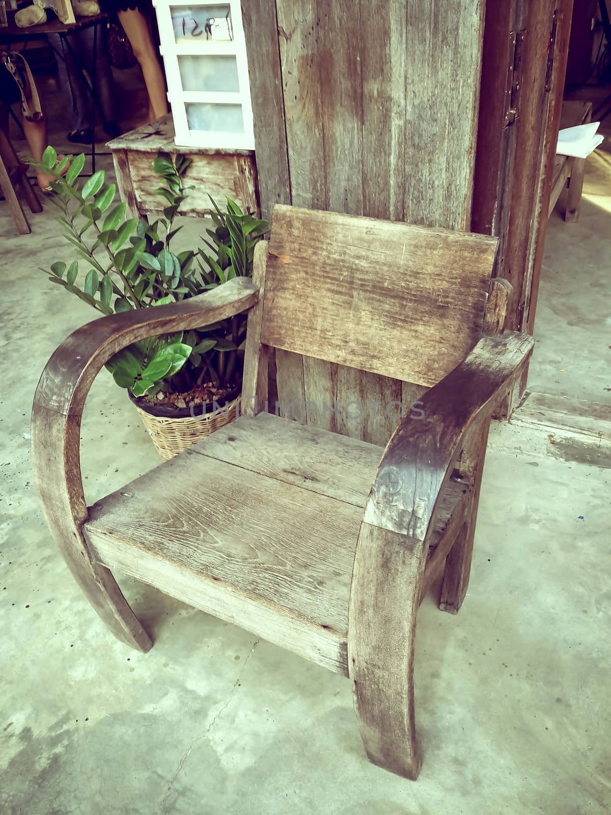 Wooden chair standing on wood  Front door of country house. House made from wood.