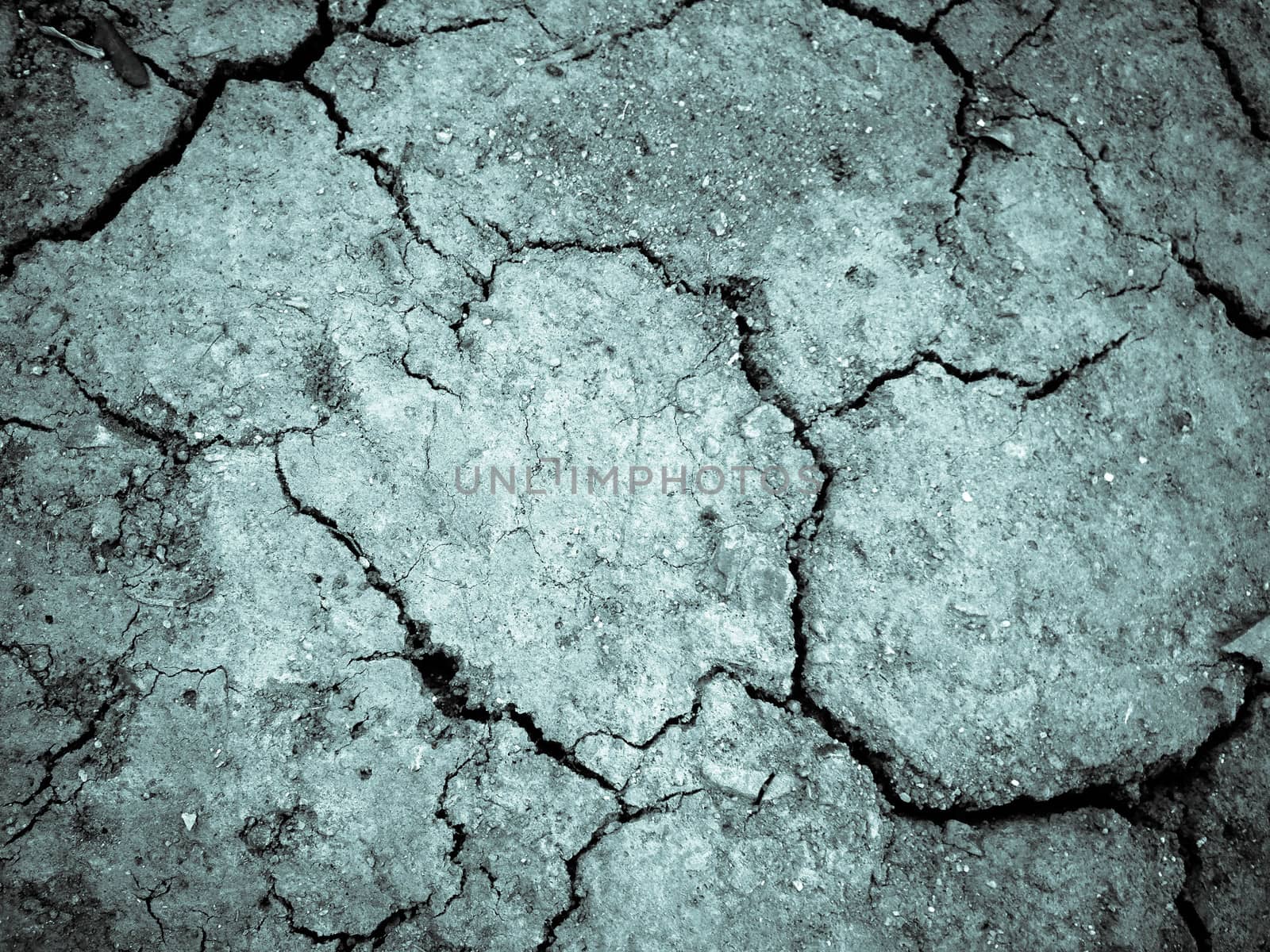 Dried cracked earth soil ground texture background.