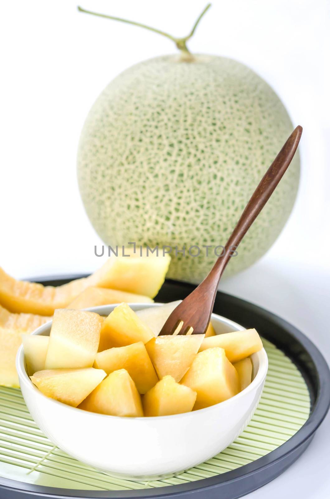 freshly cut cantaloupe melon on white background