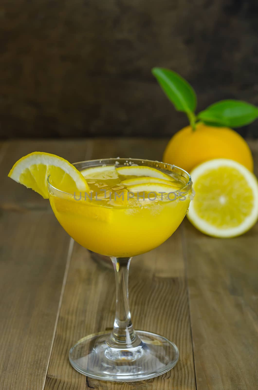 Fresh orange juice on wooden table over grunge background