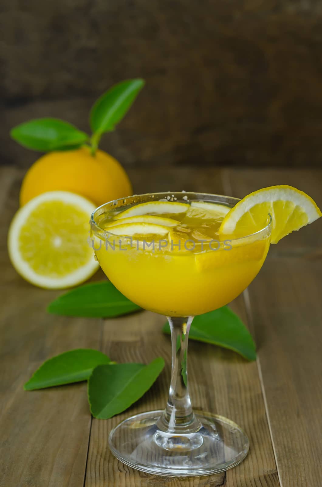 Fresh orange juice on wooden table over grunge background