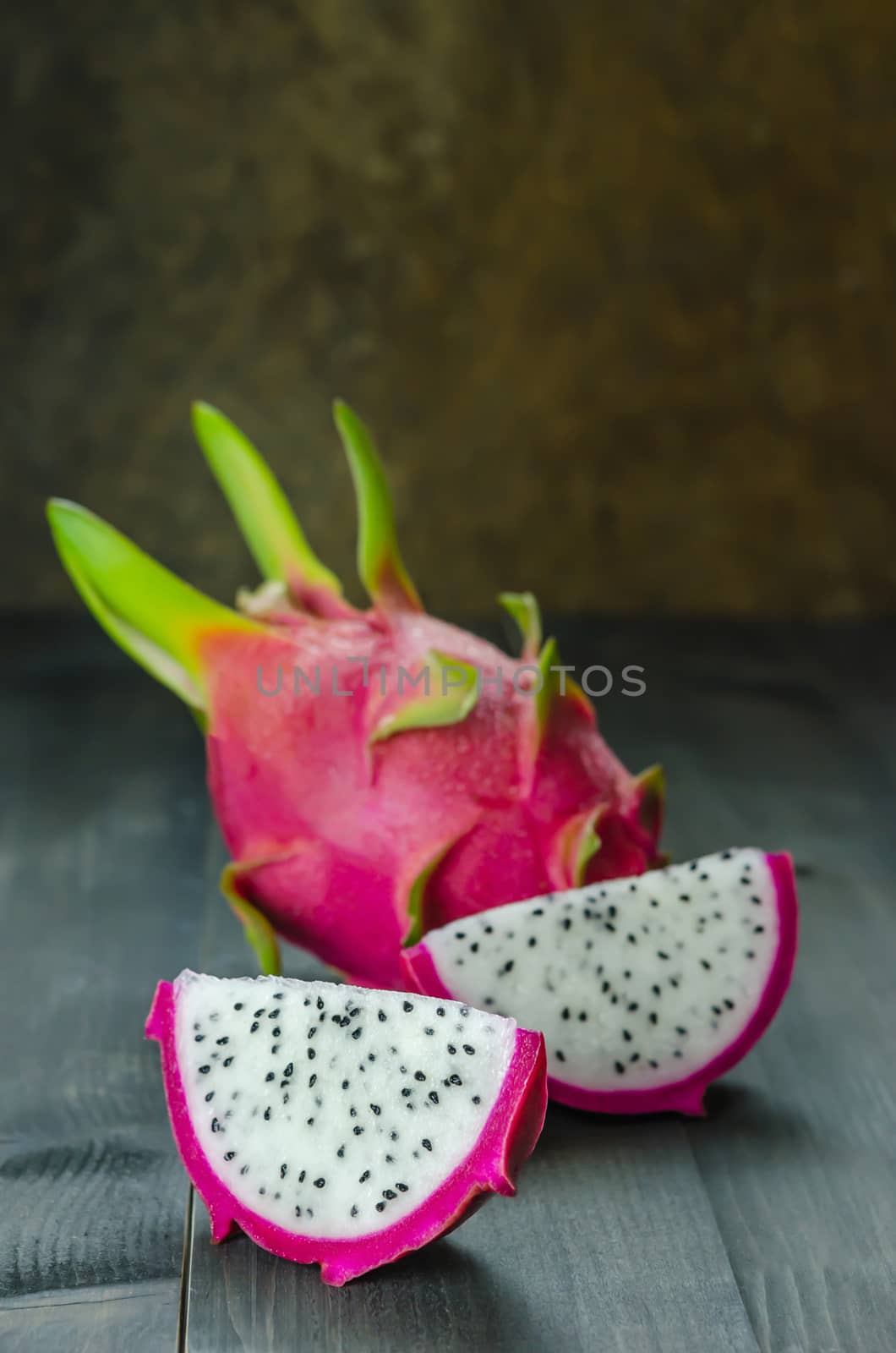 Ripe Dragon fruit or Pitaya with slice on wooden background , still life