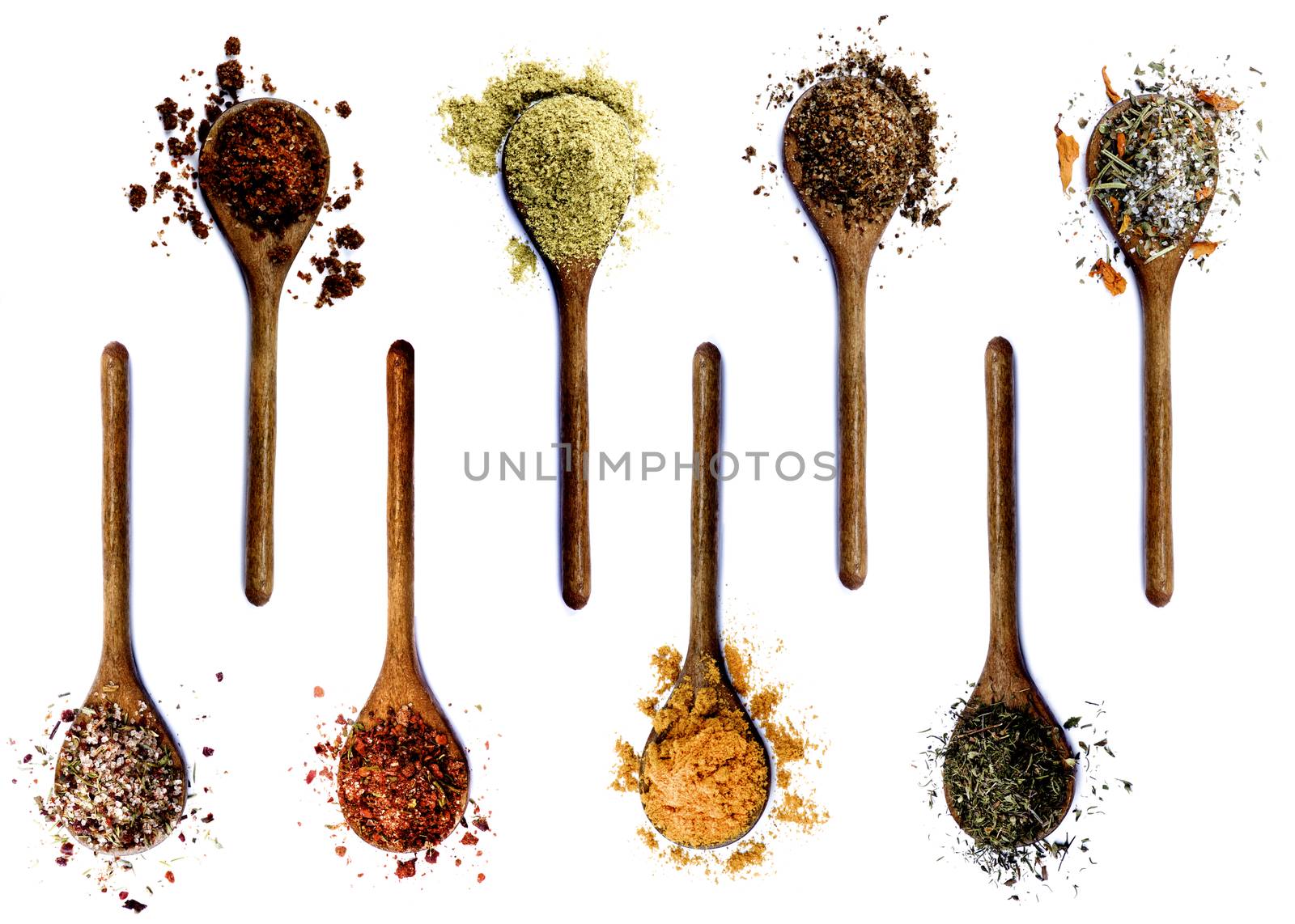 Collection of Various Spices in Wooden Spoons: Dried Paprika, Cumin Powder, Salt with Petals, with Chili and with Cayenne Pepper, Curry Powder and Thyme isolated on White background