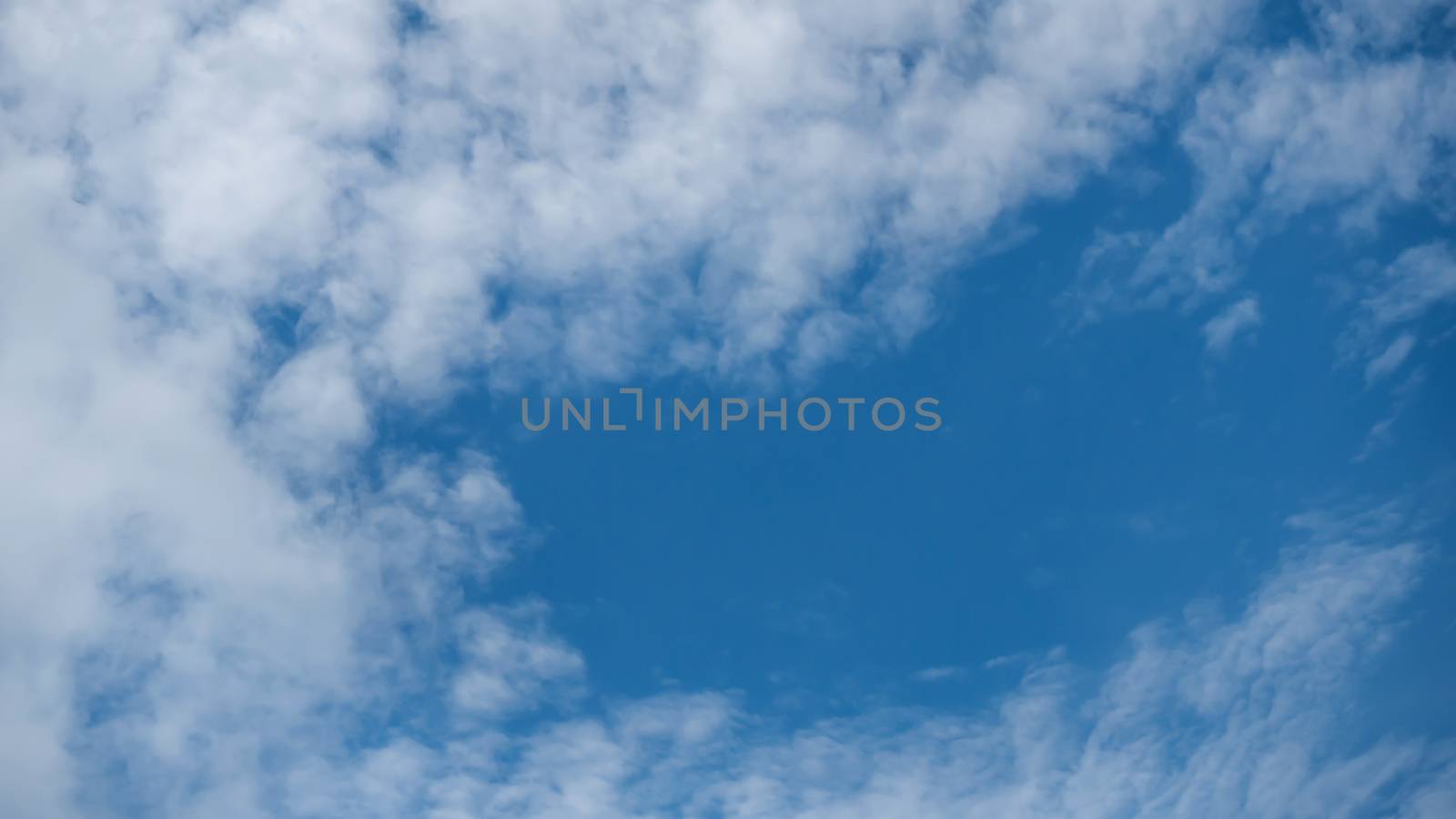 White fluffy clouds on a blue sky background