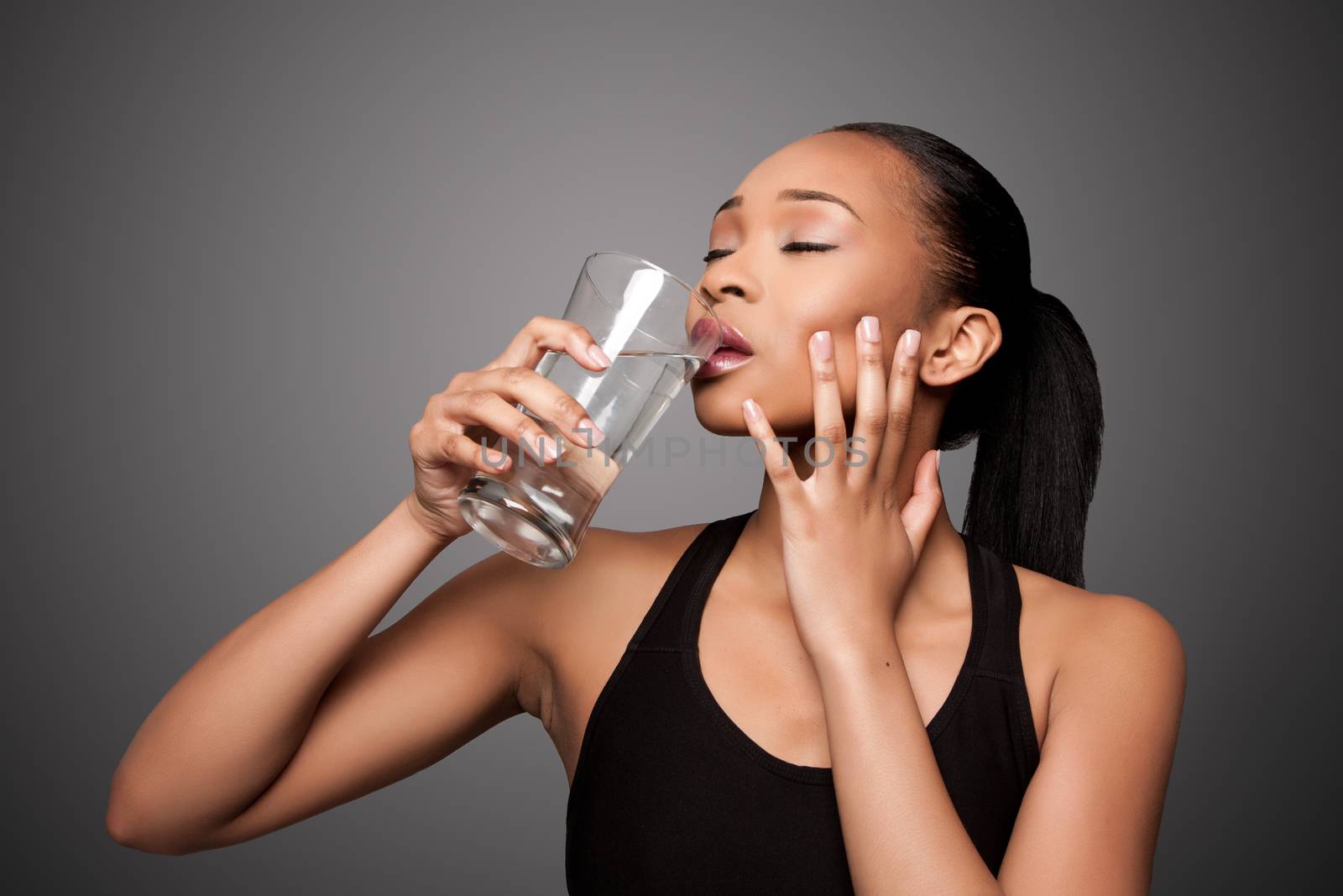 Happy healthy black asian woman enjoying water by phakimata