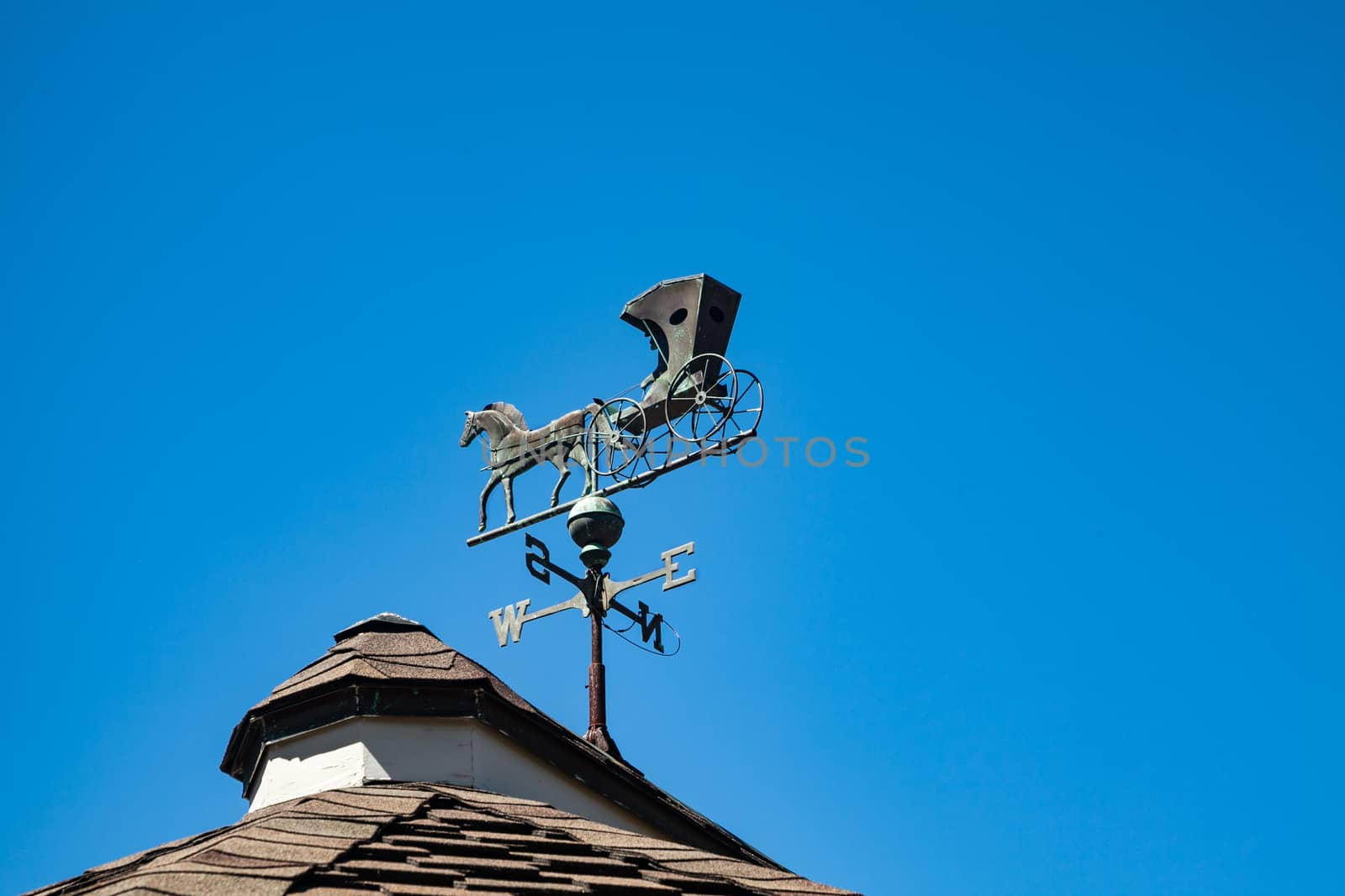 A Weather Vane which has a horse and carriage