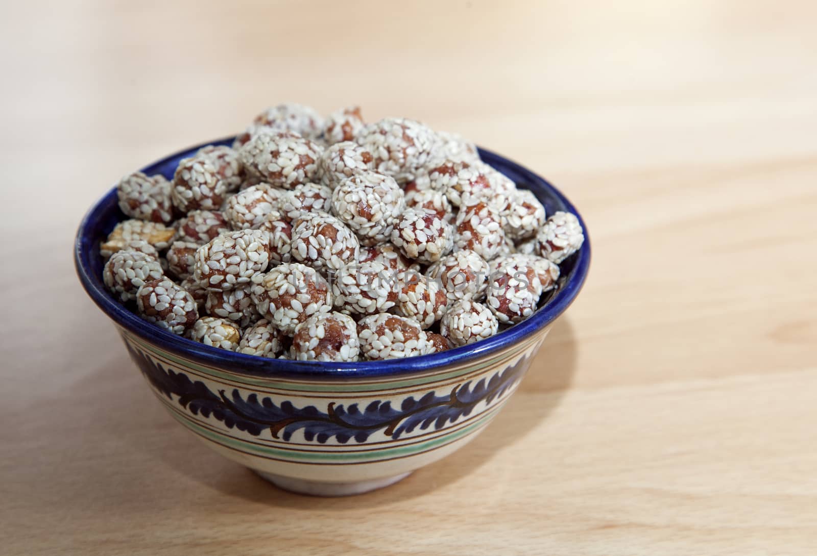 Nuts covered with honey and sesame in an oriental bowl