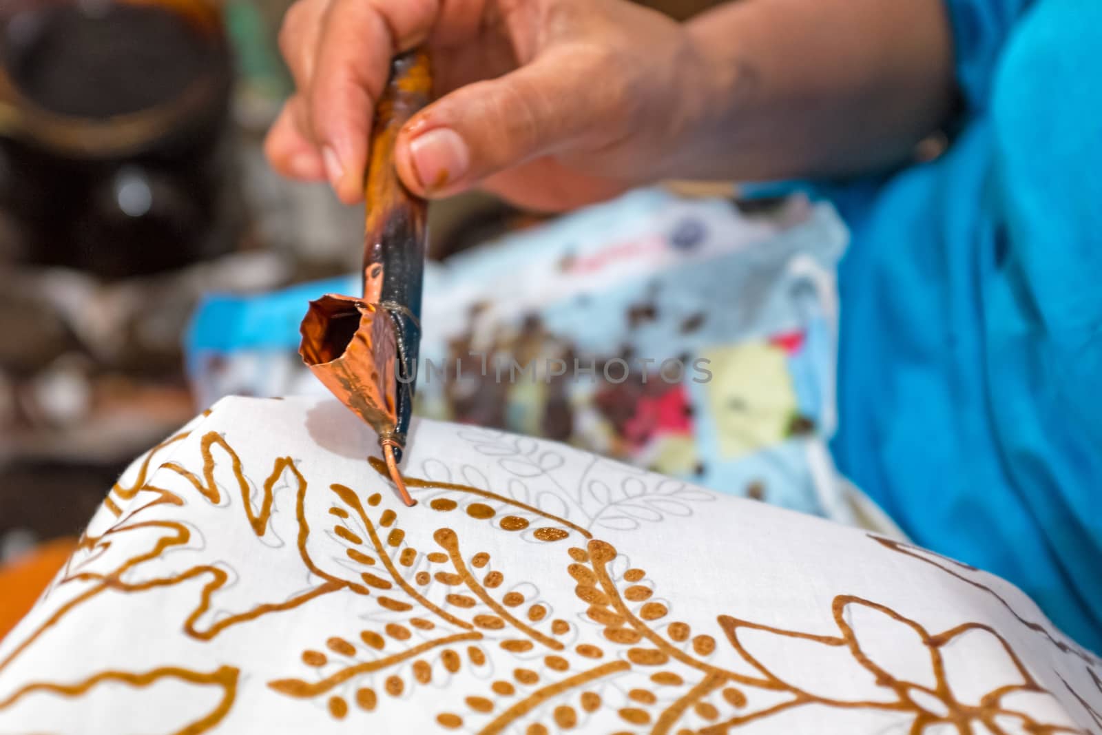 Painting watercolor on the fabric to make Batik. Batik-making is part of Indonesian culture