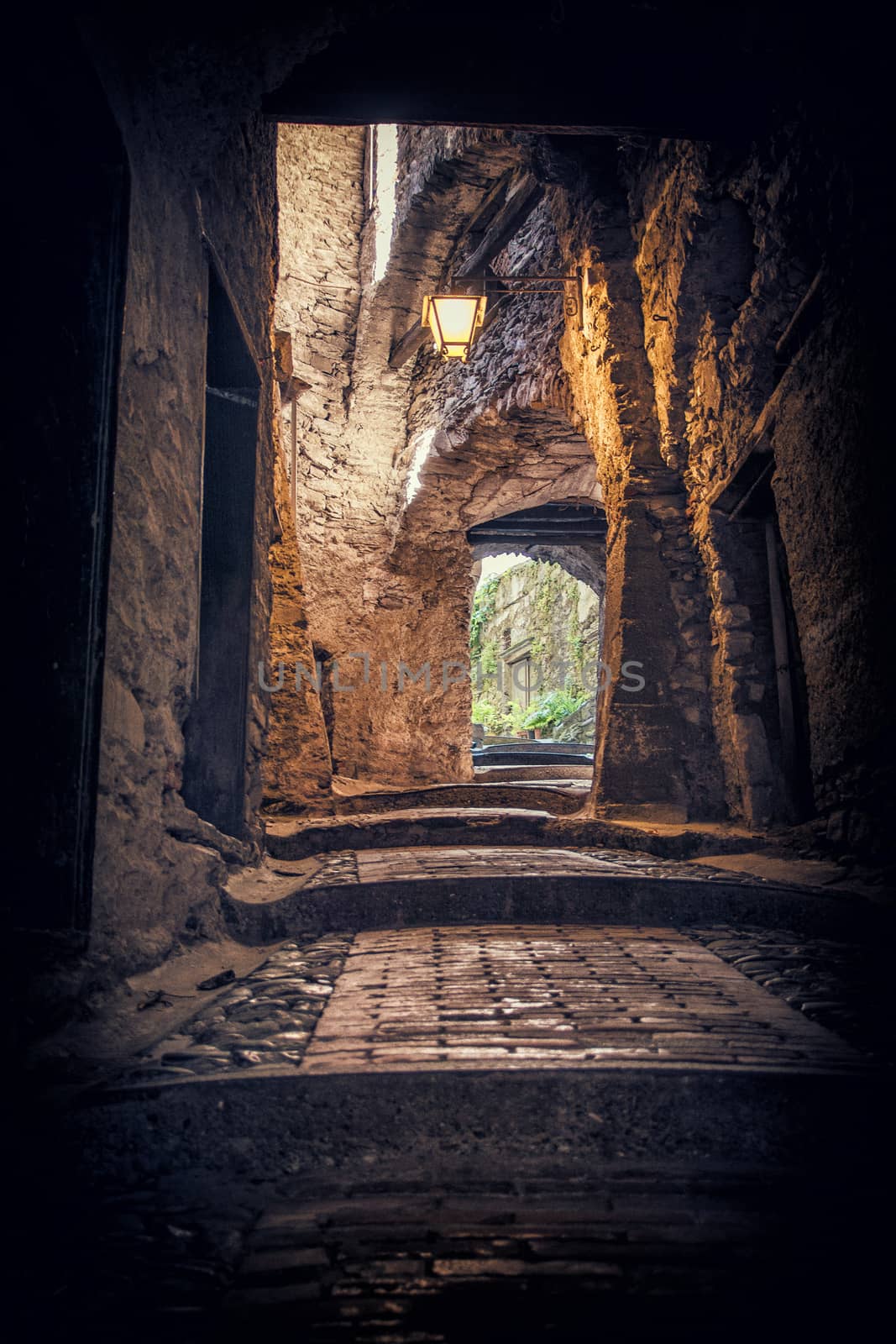 Narrow and old street or alley in italian town. Historical view of Italy