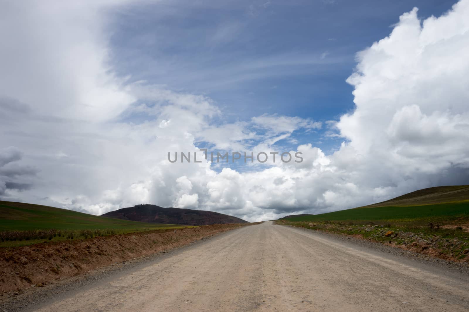 mountain road towards blue sky