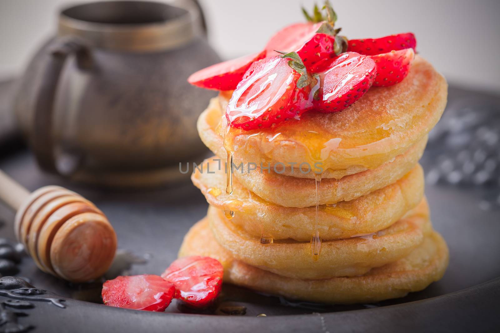 Stack of sweet pancakes with strawberry and honey. by supercat67